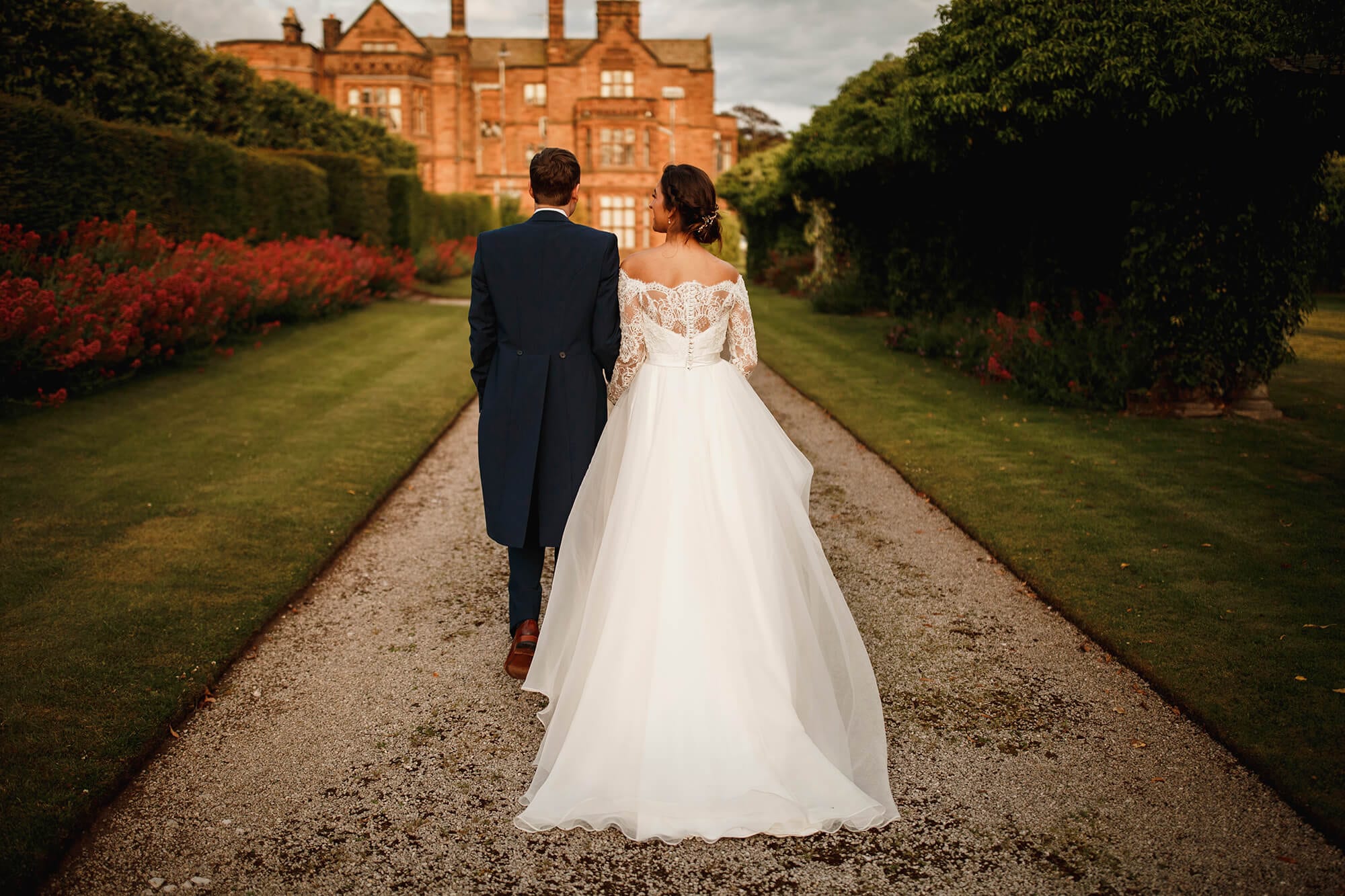Bride and groom walking to Thornton Manor House