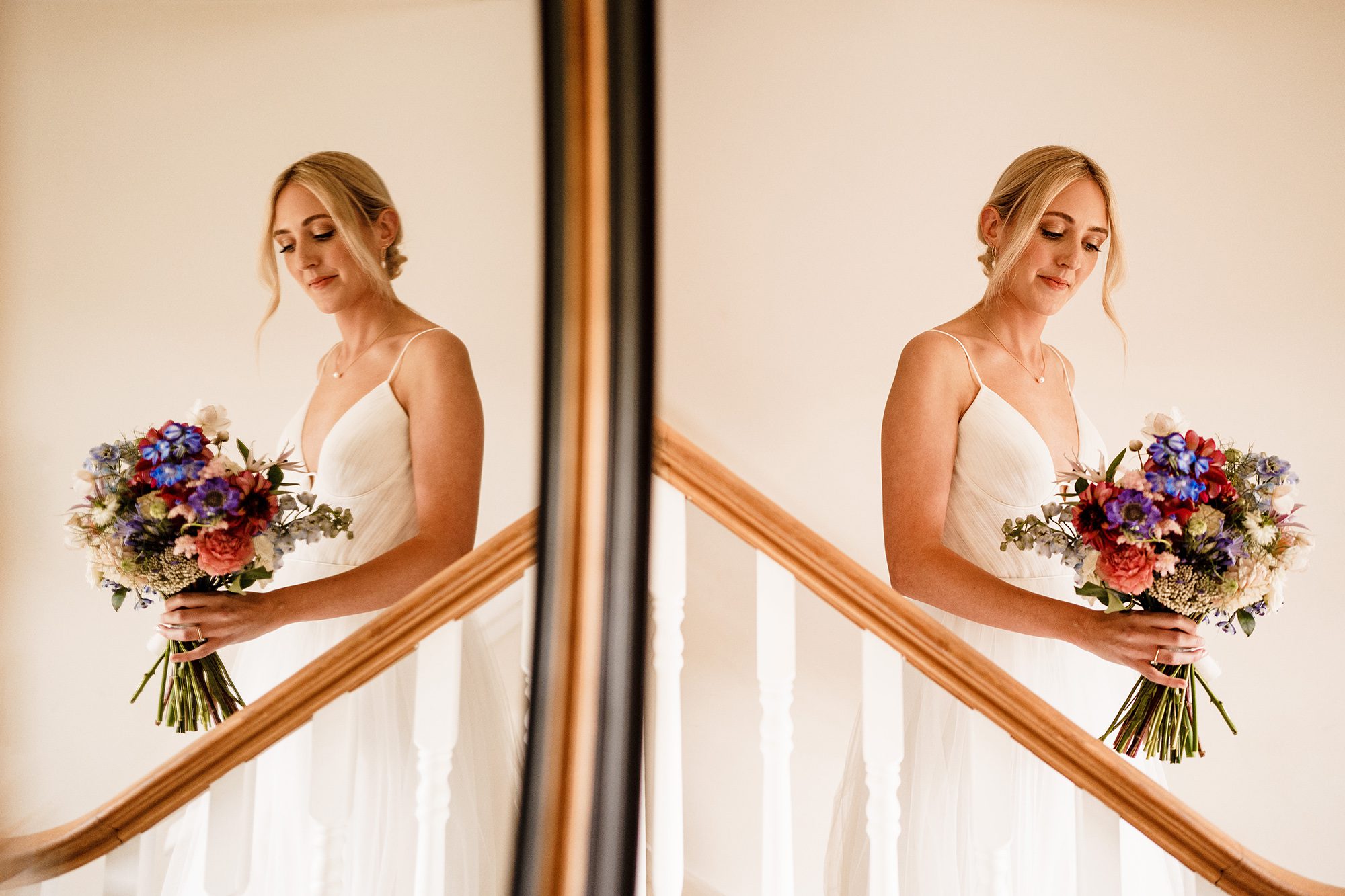 Seeing double; mirror image of bride posing on stairwell at Primrose Hill Farm in Banbury Oxfordshire.