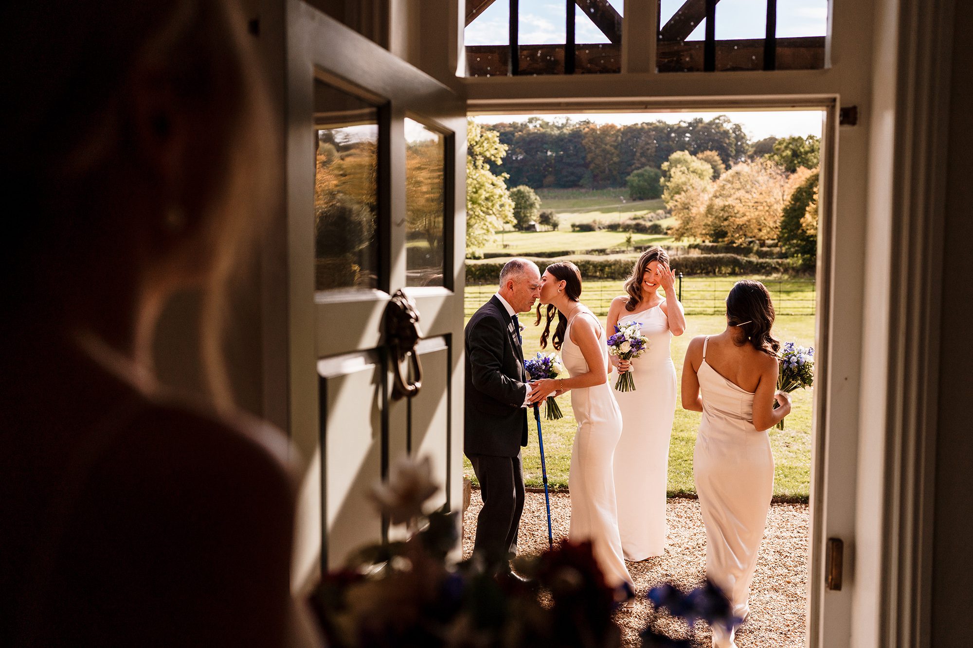Father of the bride prepares to walk his daughter up the aisle at Primrose Hill Farm with final words of encouragement from the maid of honour.