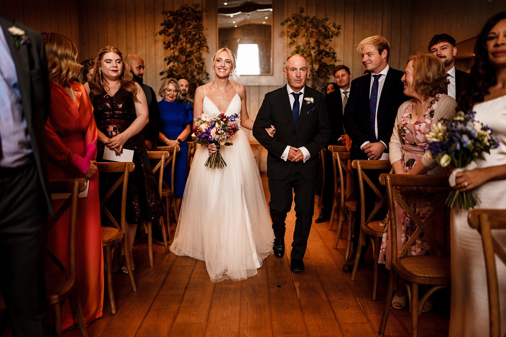 Bride beams as her father walks her up the aisle at Primrose Hill Farm.