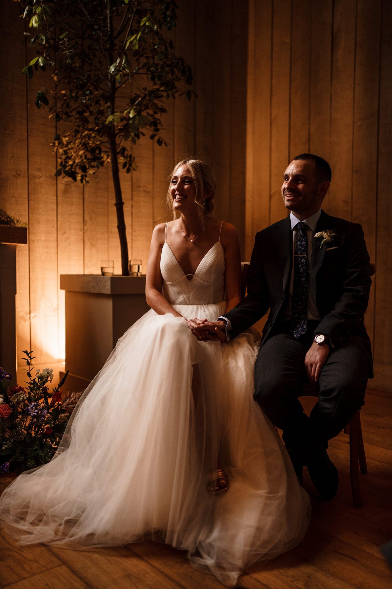 Newlyweds sit in pose after wedding ceremony at Primrose Hill Farm in Banbury, Oxfordshire.