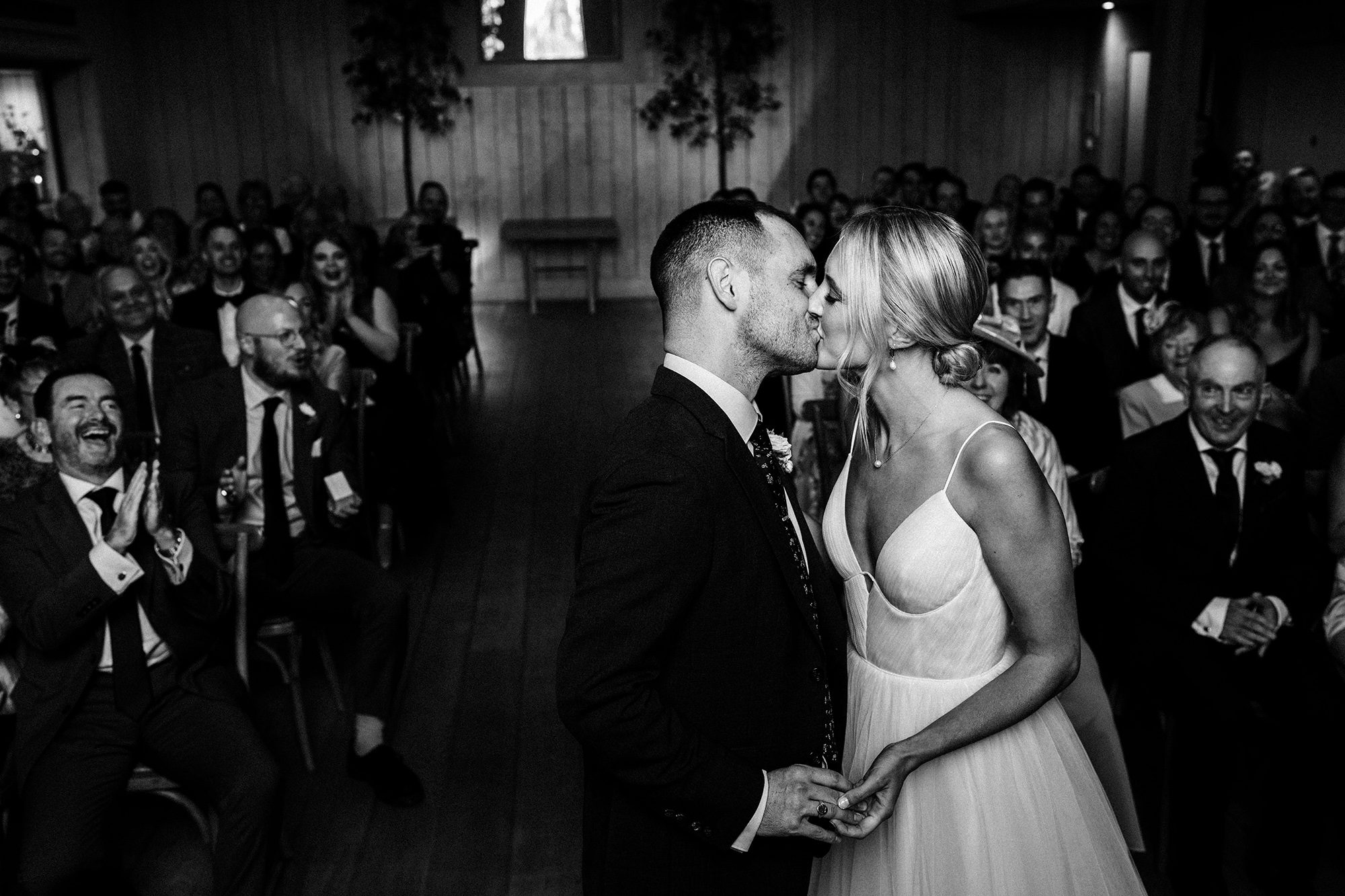 Husband and Wife kiss at the altar after wedding ceremony at Primrose Hill Farm.