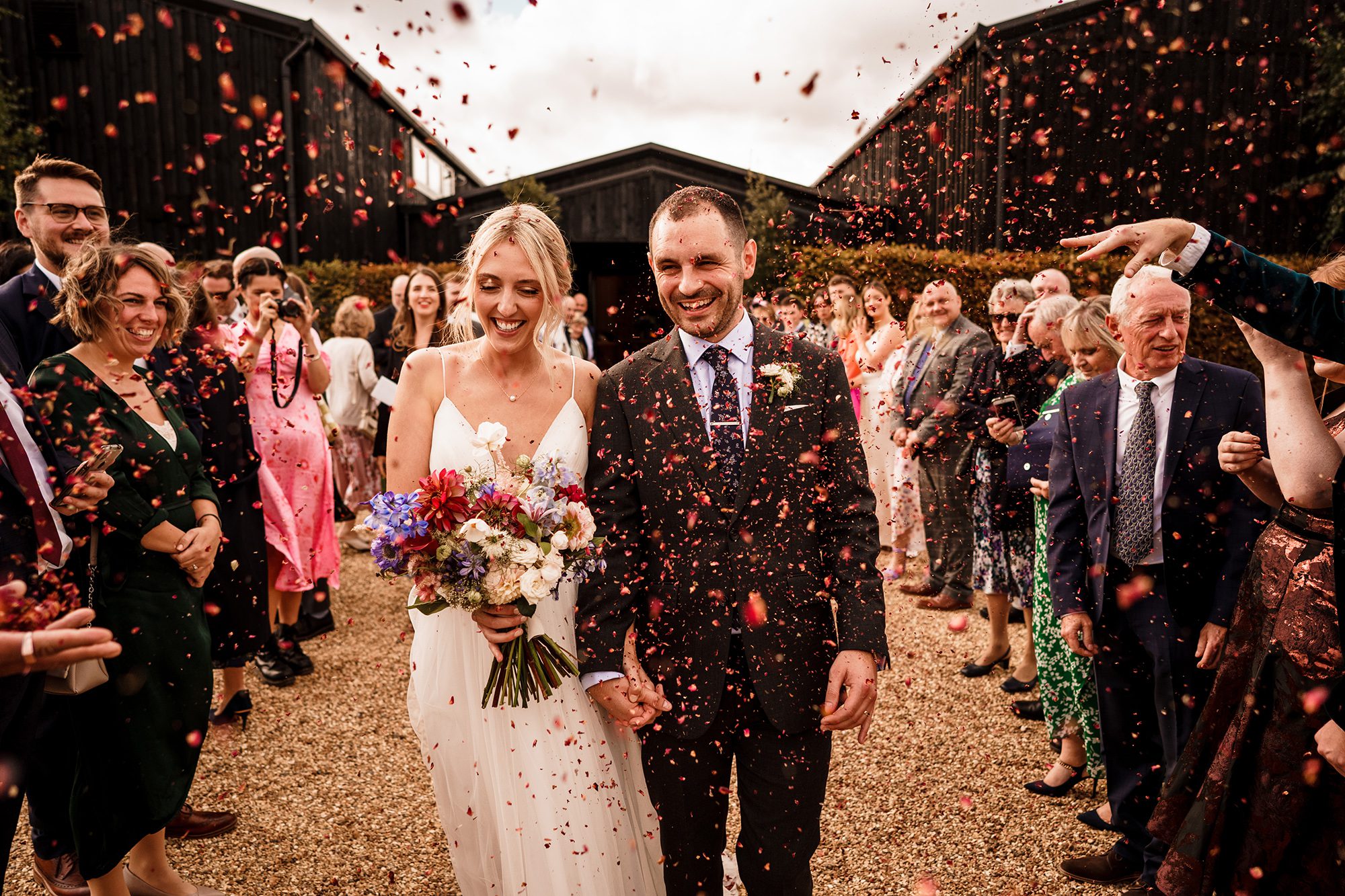 Confetti showers the newlyweds outdoors at Primrose Hill Farm.