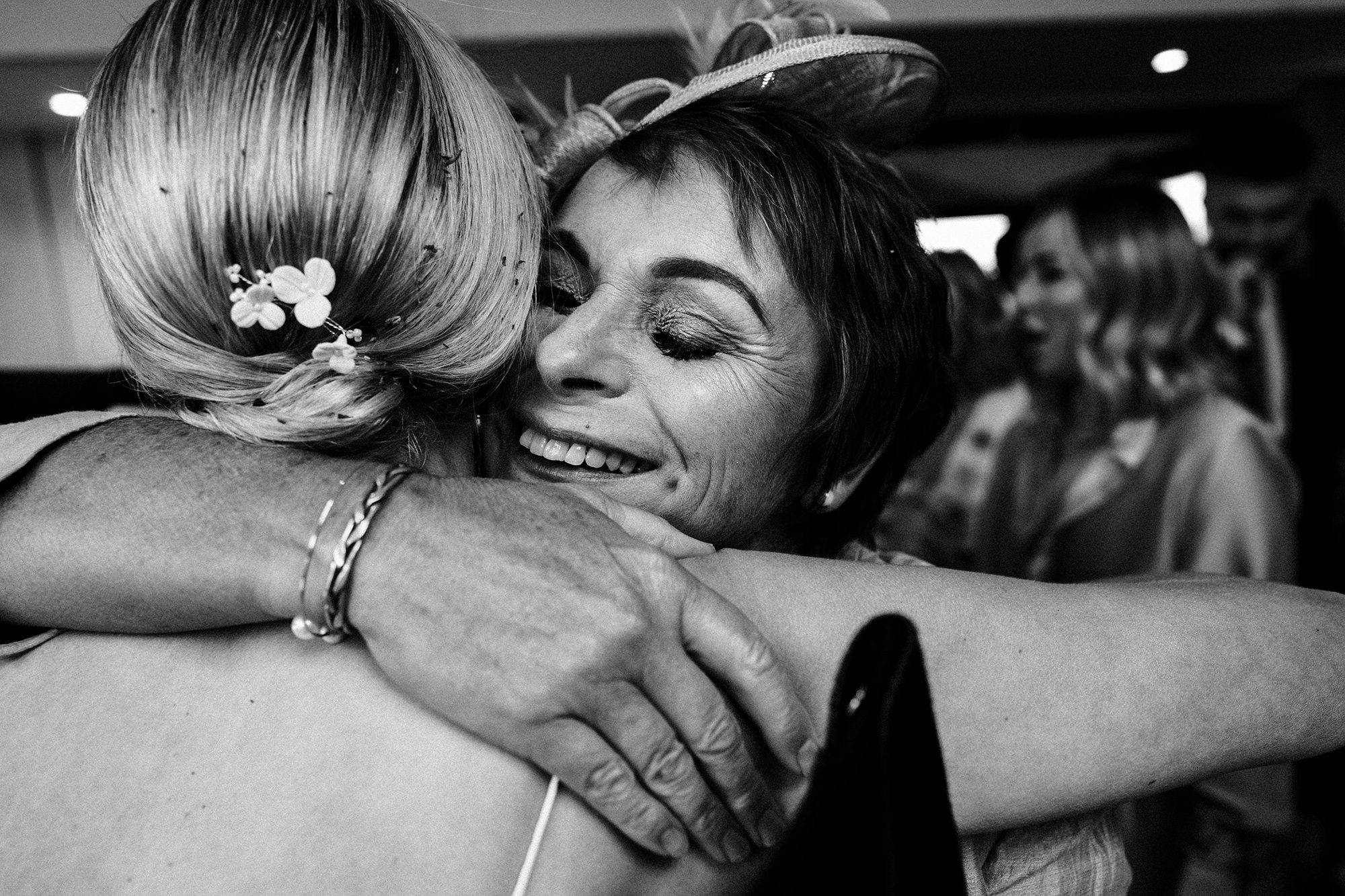 A close embrace between the bride and her mother in law after wedding ceremony.