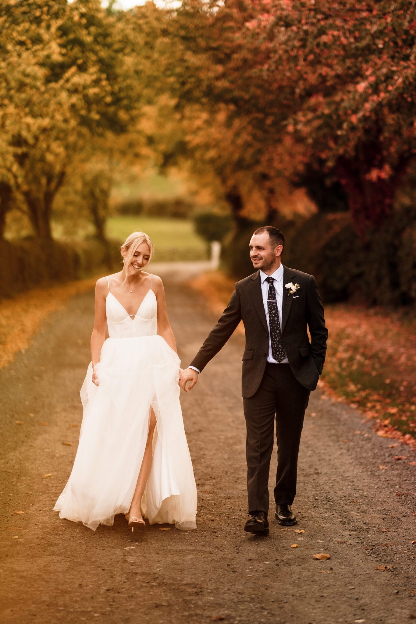 Bride and Groom stroll through the Autumn Oxfordshire countryside at Primrose Hill Farm.