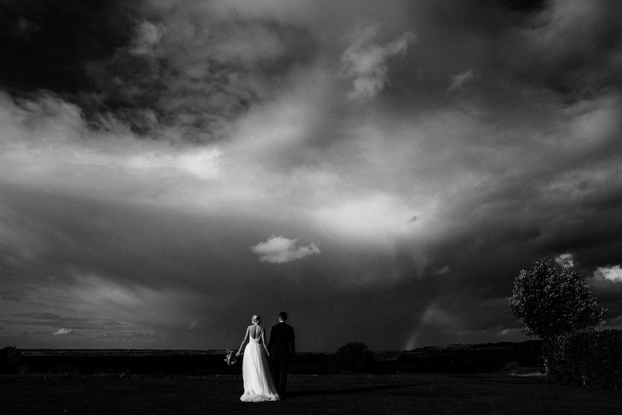 Stunning panoramic with newlyweds centre stage in front of a perfect autumn storm.