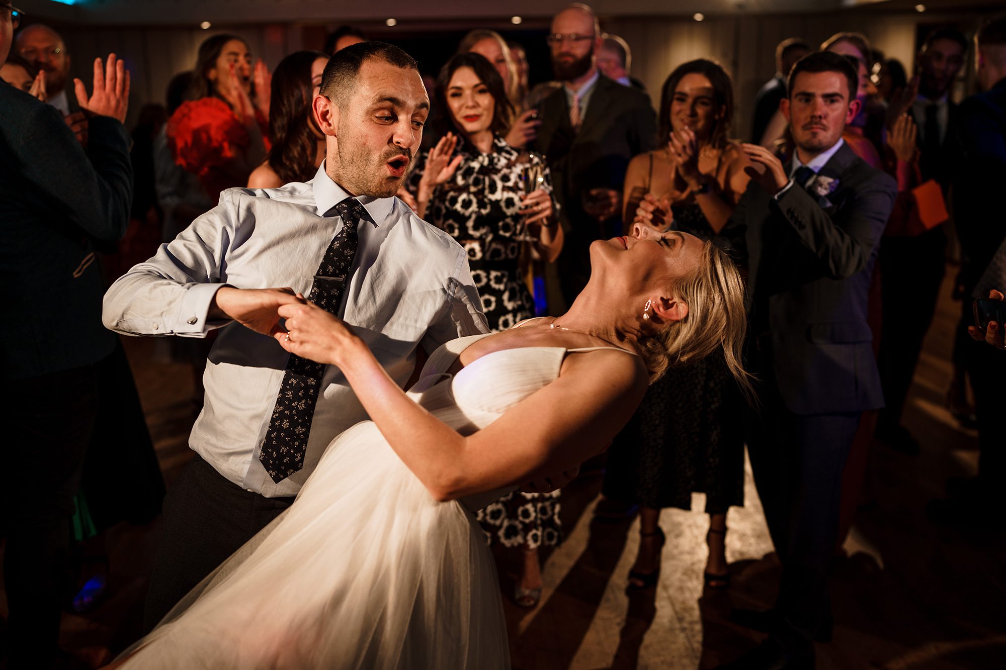 Husband and wIfe turning it on during wedding reception dance.