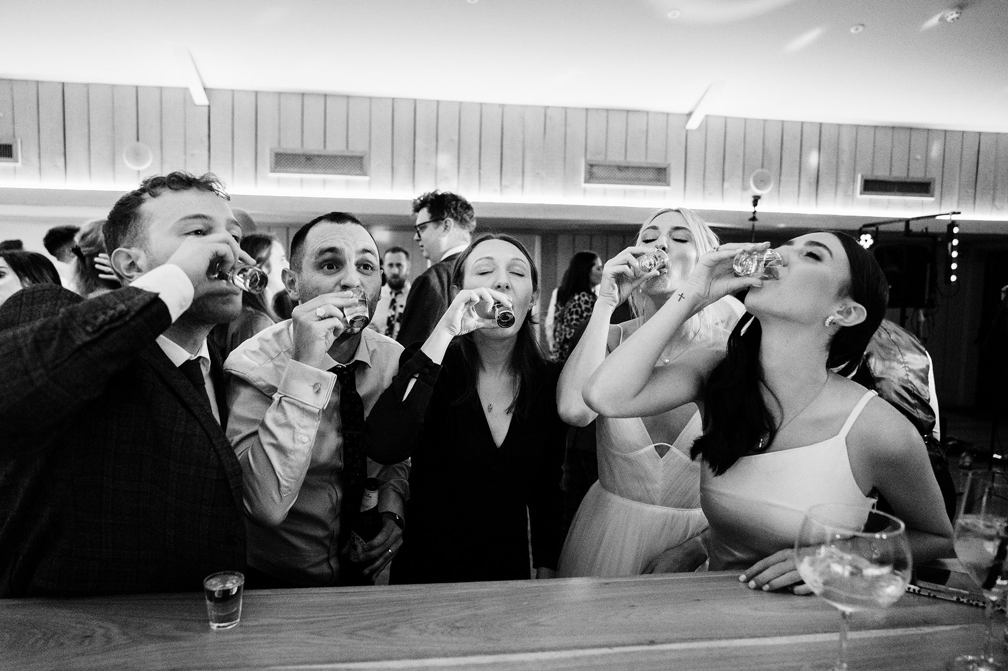 Taking shots as bride, groom and guests relax at Primrose Hill Farm wedding reception.