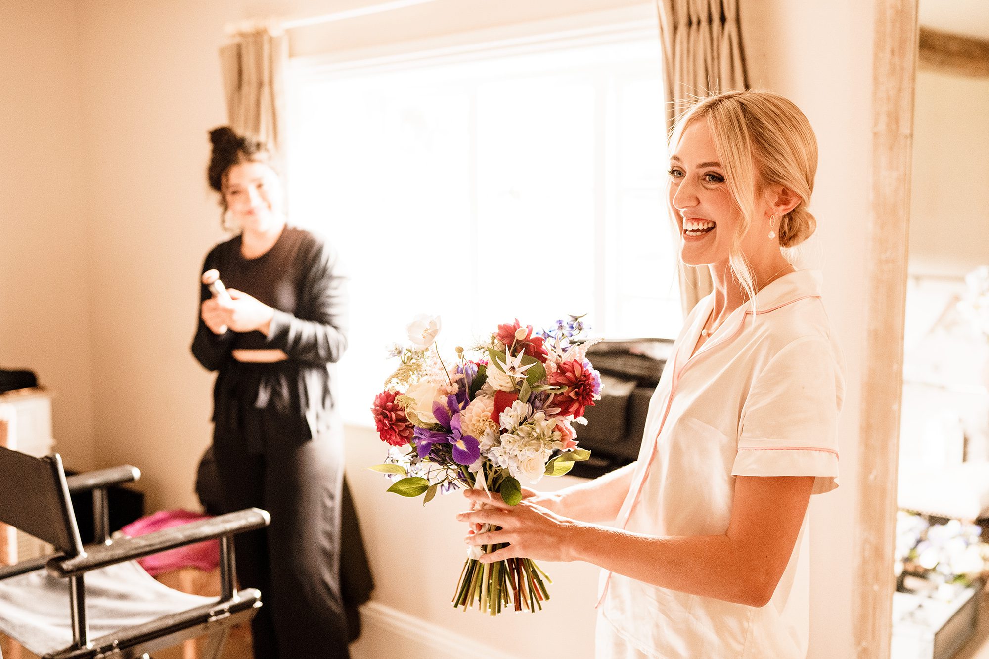 Bride laughing and joking with bouquet at Primrose Hill Farm.