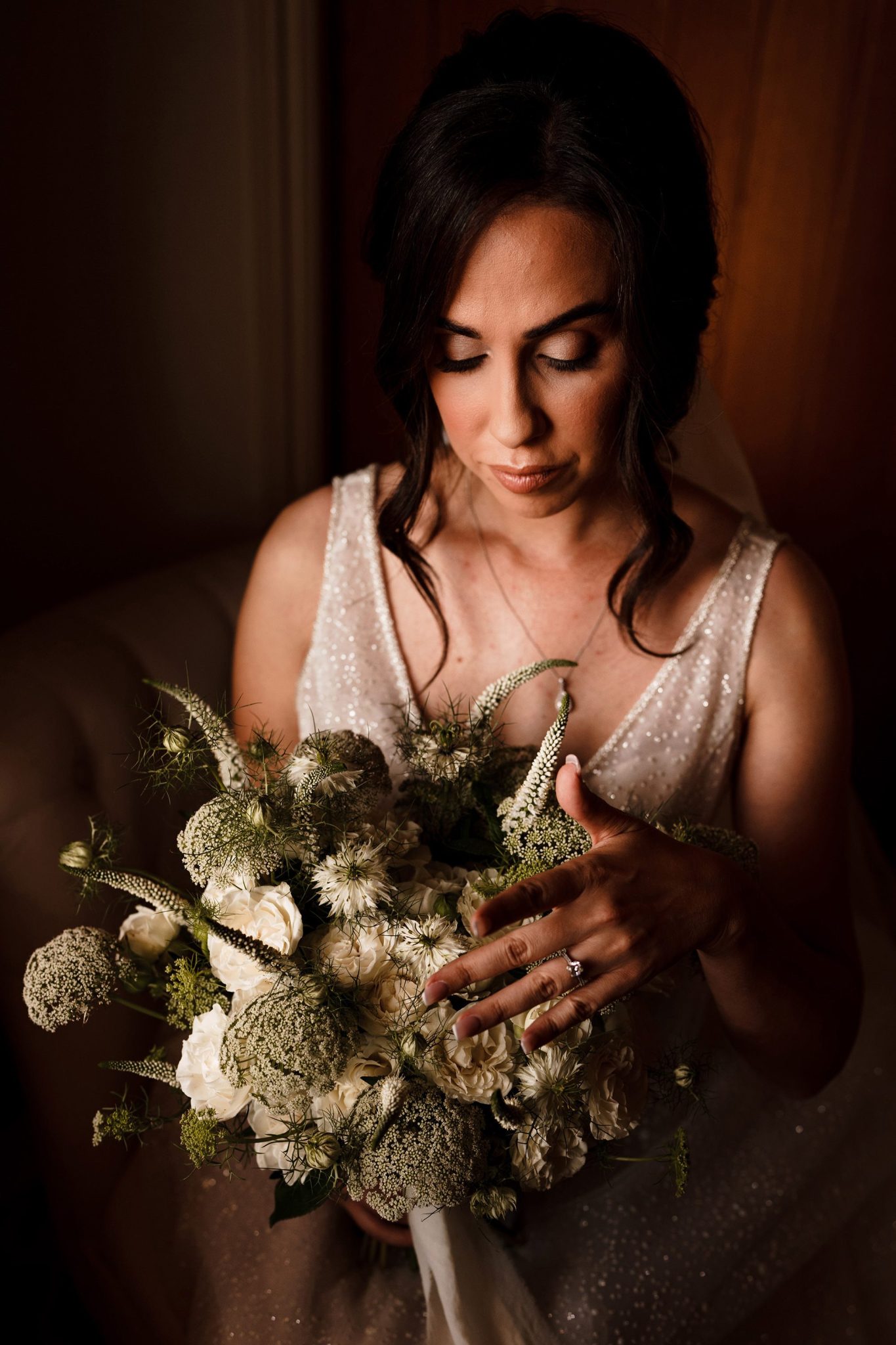 Caswell House bride looking at her bouquet