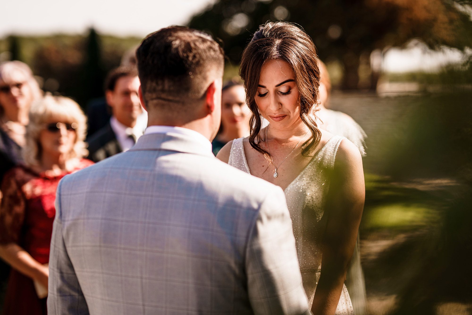 bride with eyes closed during Caswell House wedding ceremony