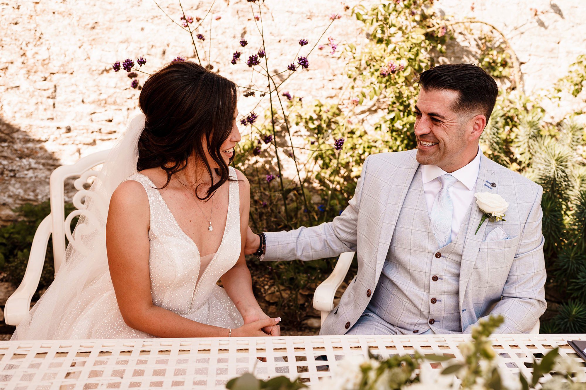 Caswell House flowers in the background of wedding couple