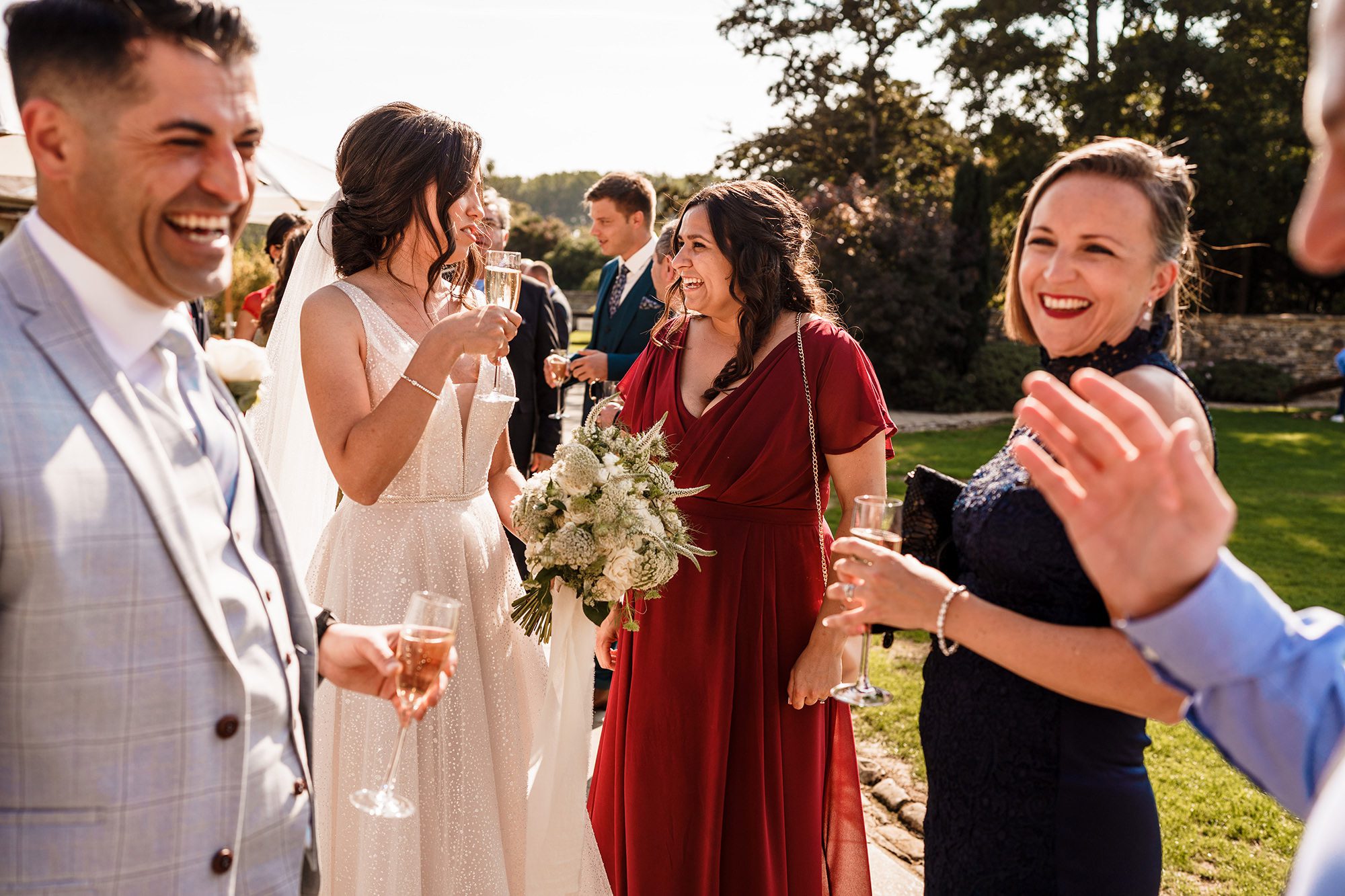 wedding guests smiling in the Oxfordshire sunshine