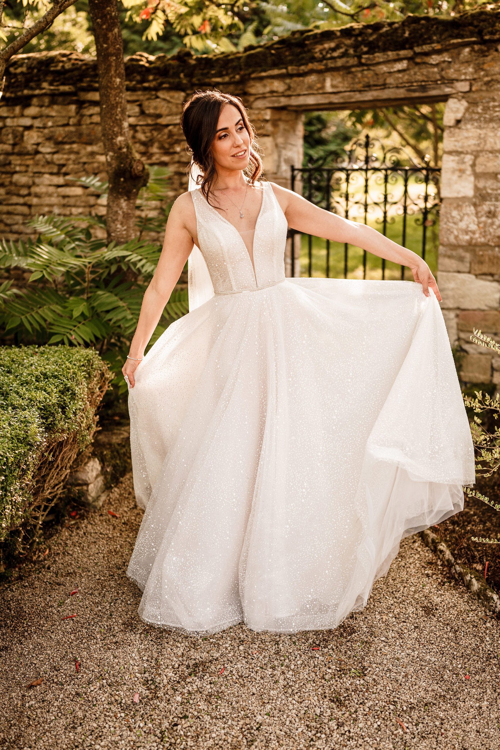 bride enjoying her wedding dress in the Caswell House walled garden