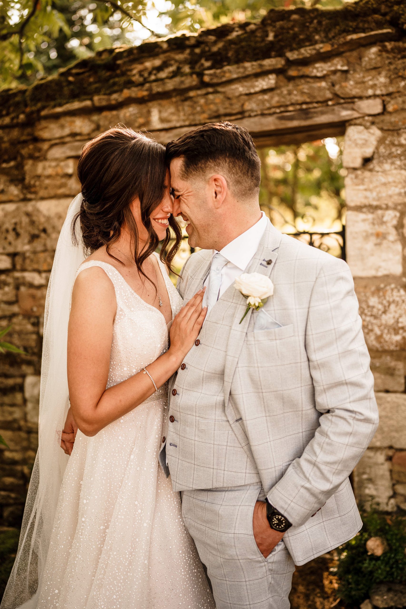 bride and groom put heads together for wedding photo