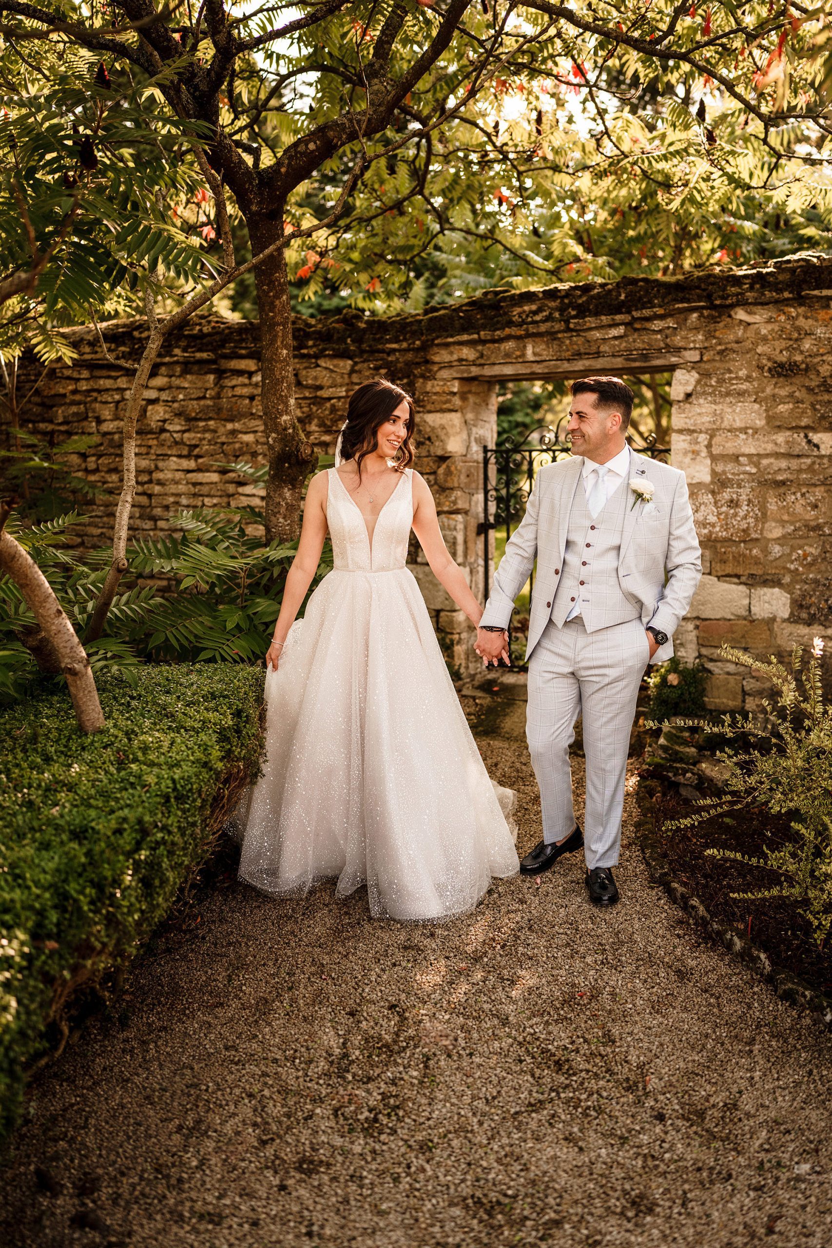 bride and groom walking the grounds of Caswell House