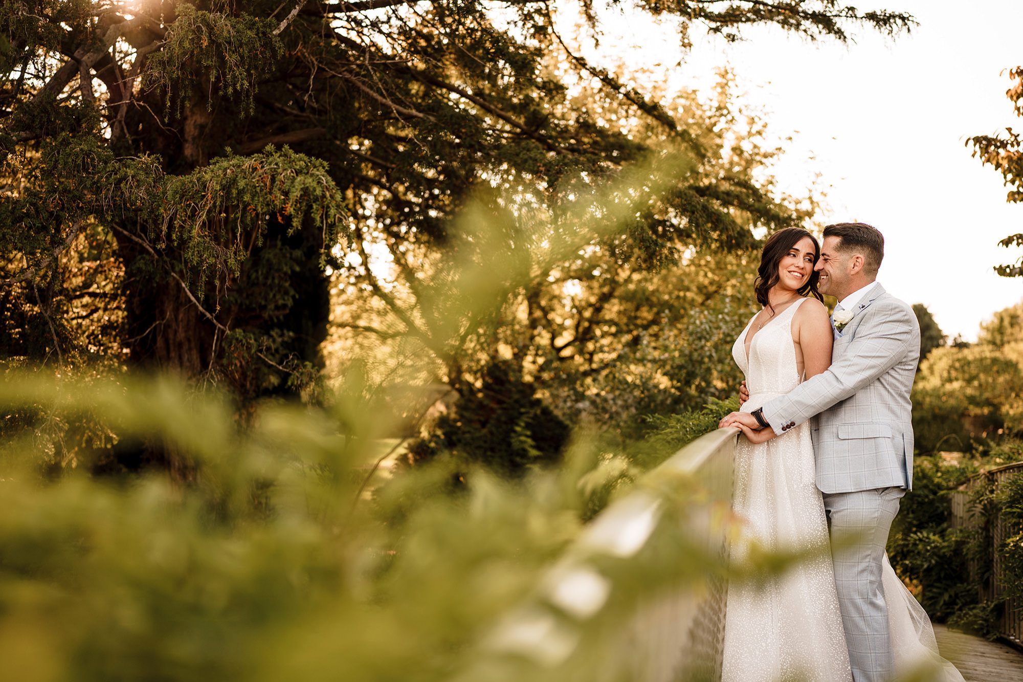 couple stand on bridge in the Caswell house grounds