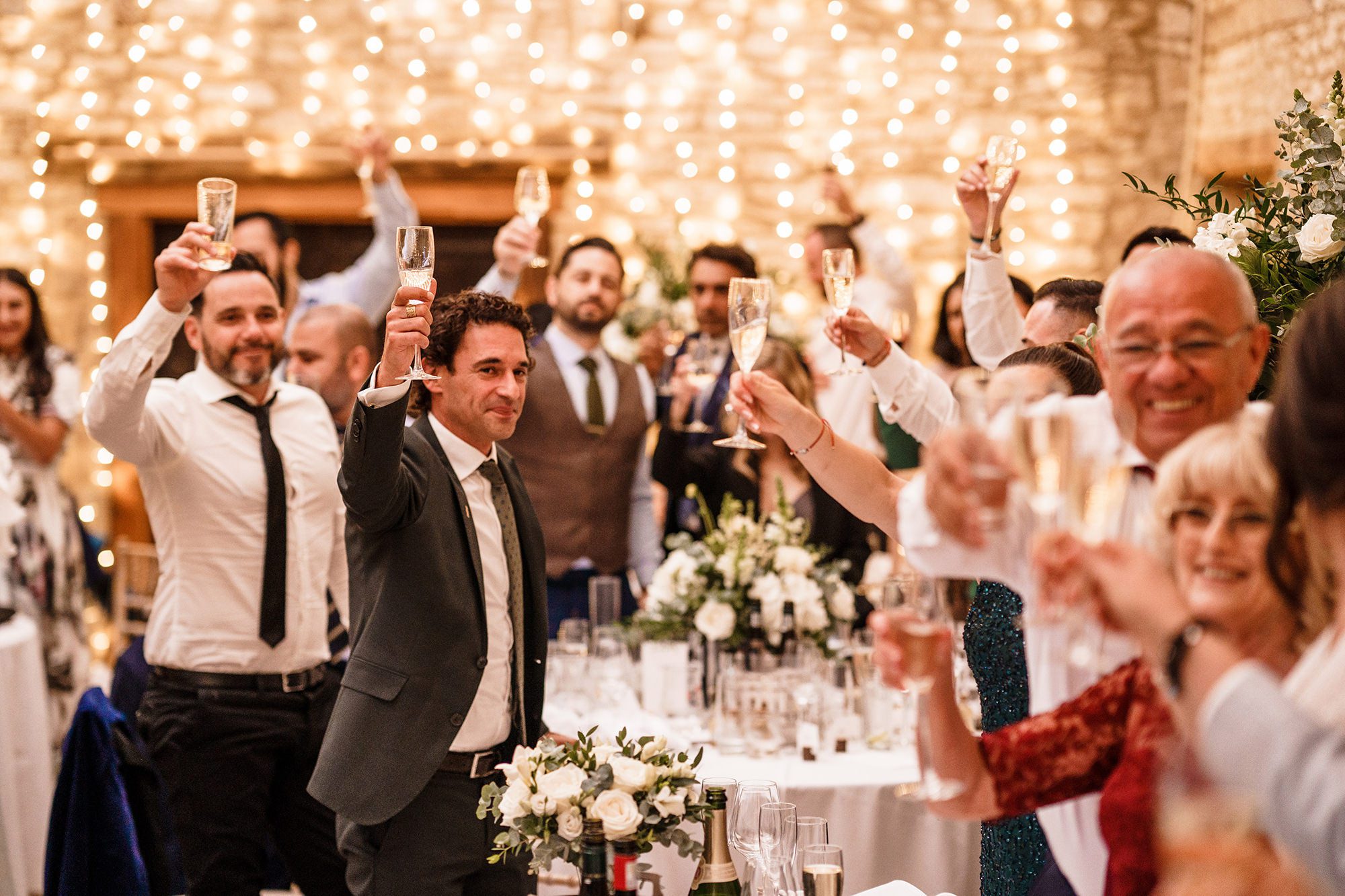 wedding guests all raising glasses at caswell house