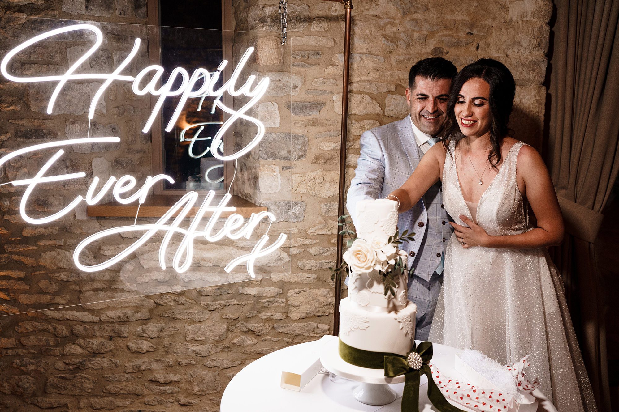 bride and groom cut the cake at caswell house