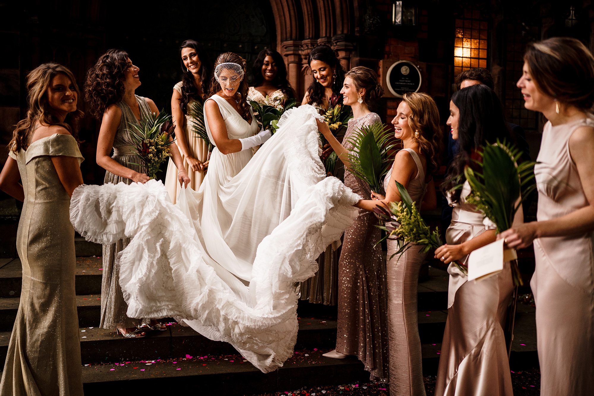bridesmaids shake brides dress outside London church