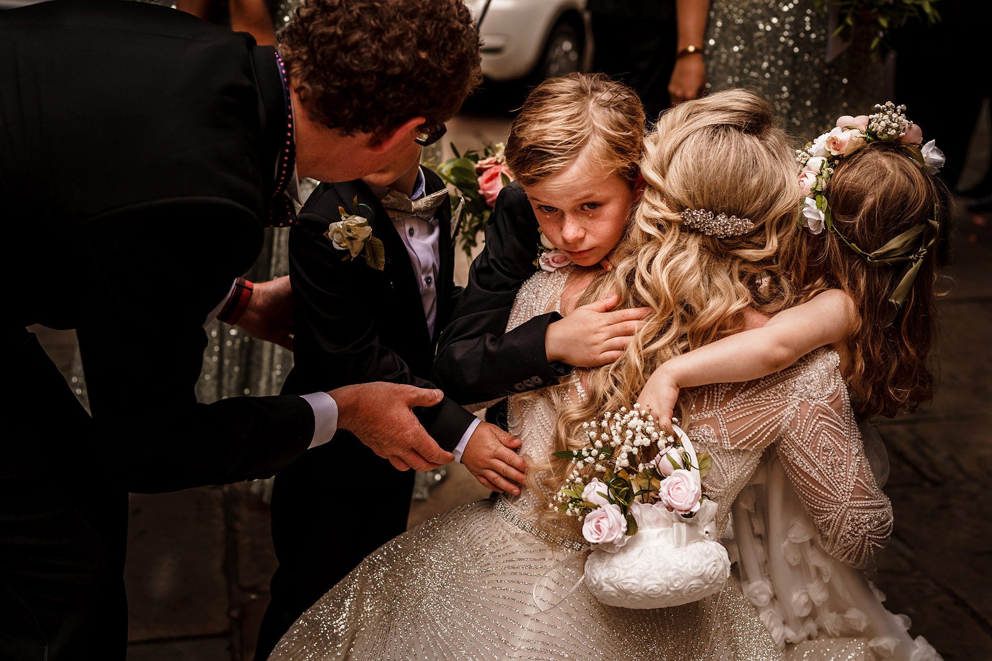outside London church bride consoles crying child