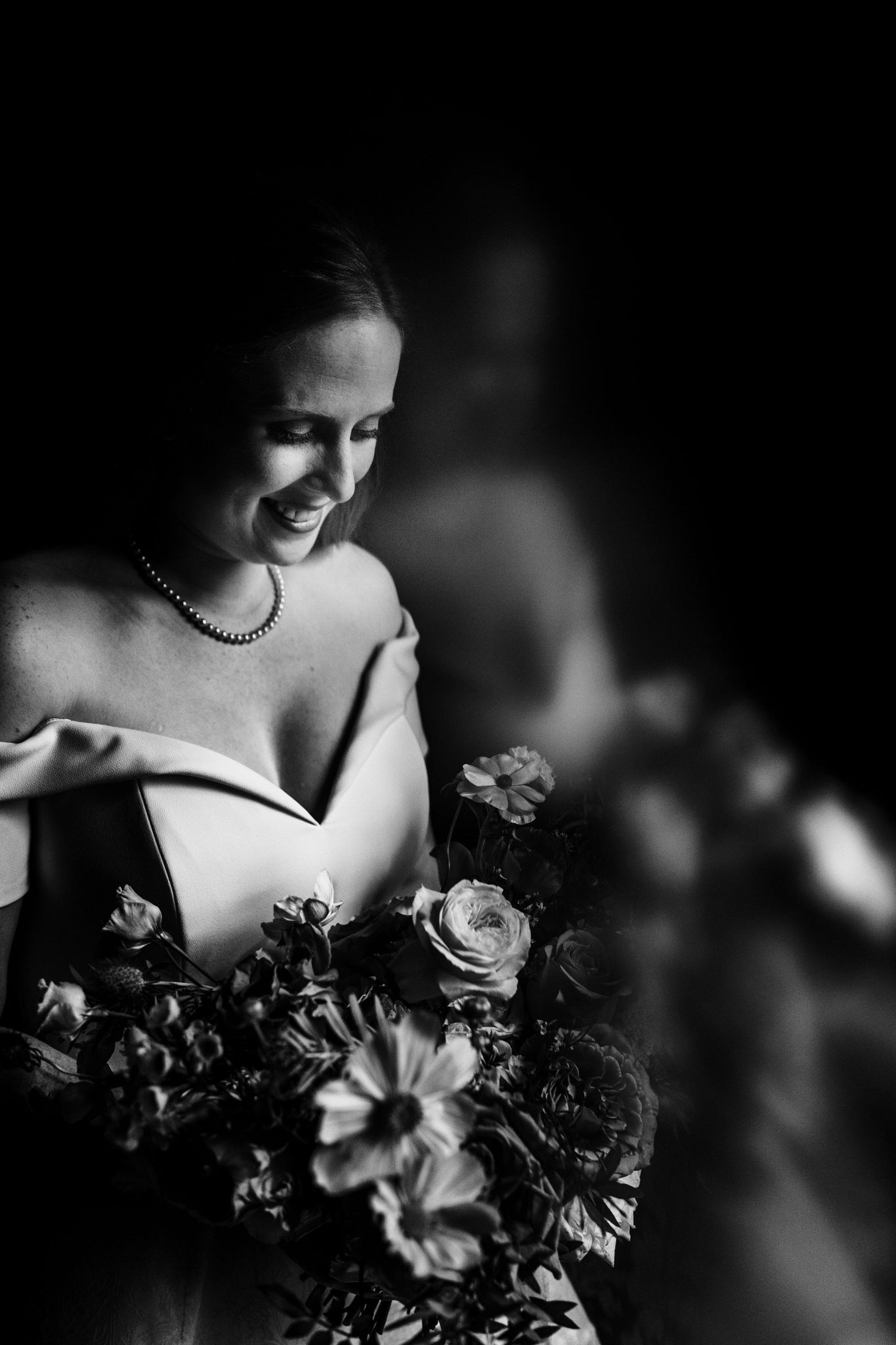 bride looks down at her flowers at Cheshire wedding