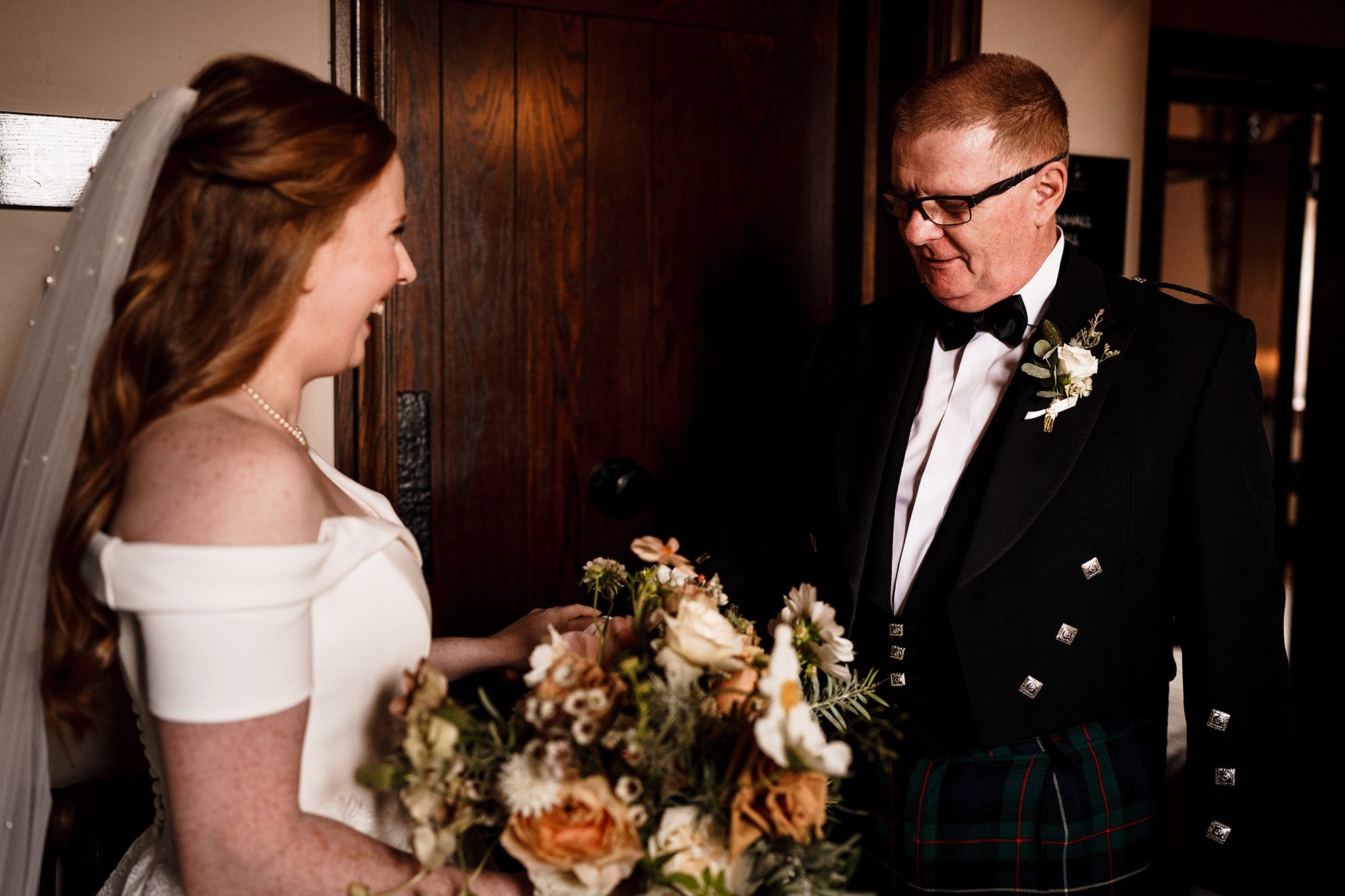 father of the bride looks at his daughter on the morning of her wedding at Peckforton Castle