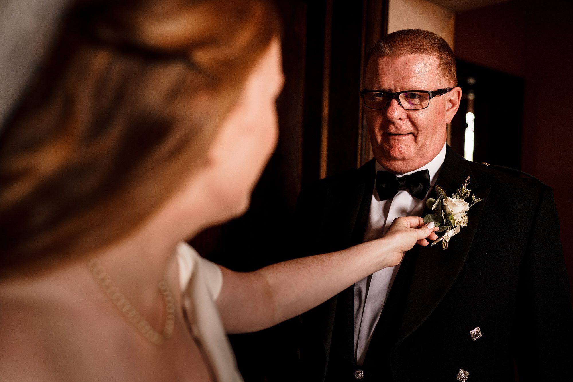bride adjusting fathers flowers