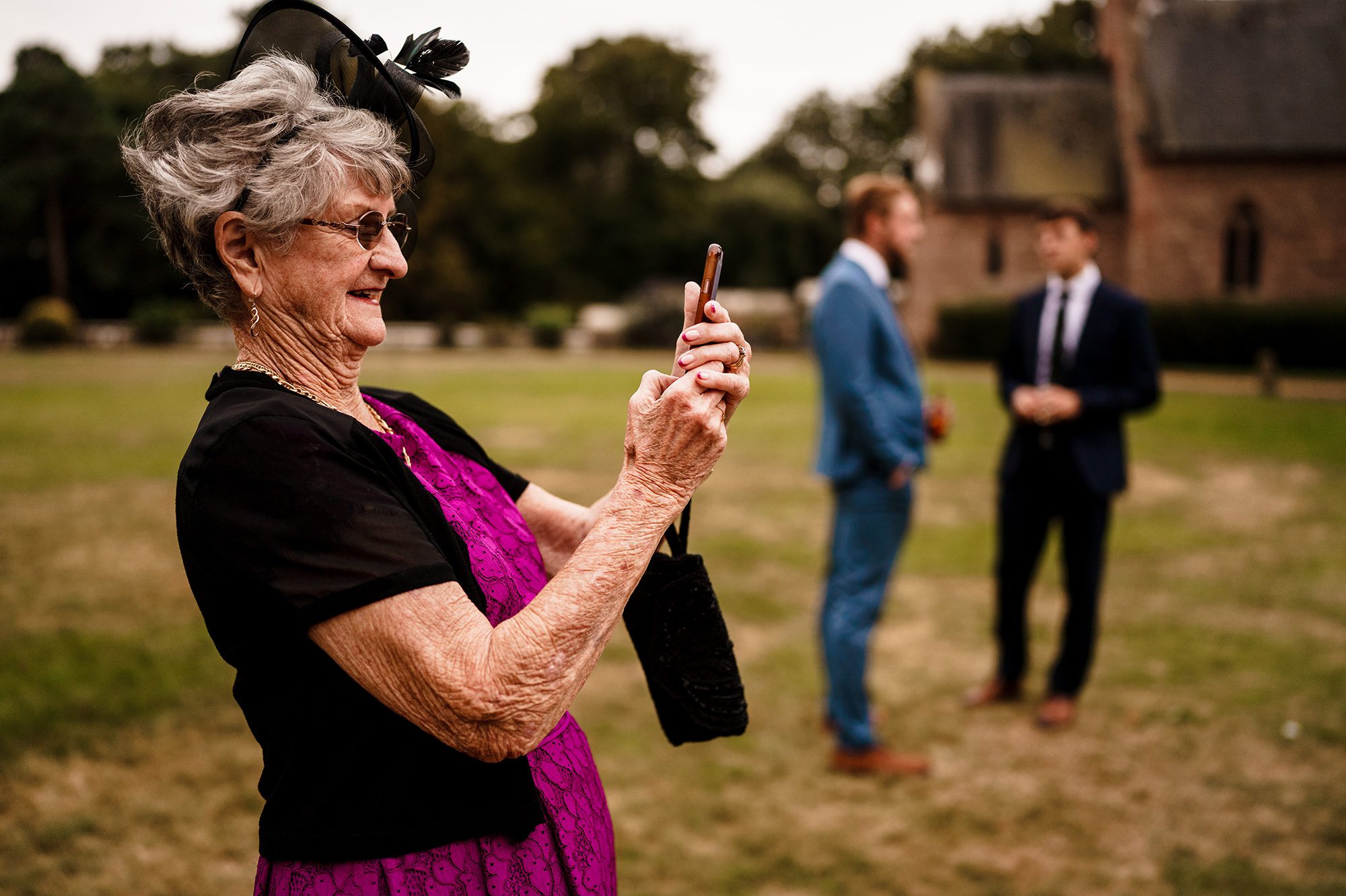 an older relative taking photos in the courtyard of Peckforton Castle