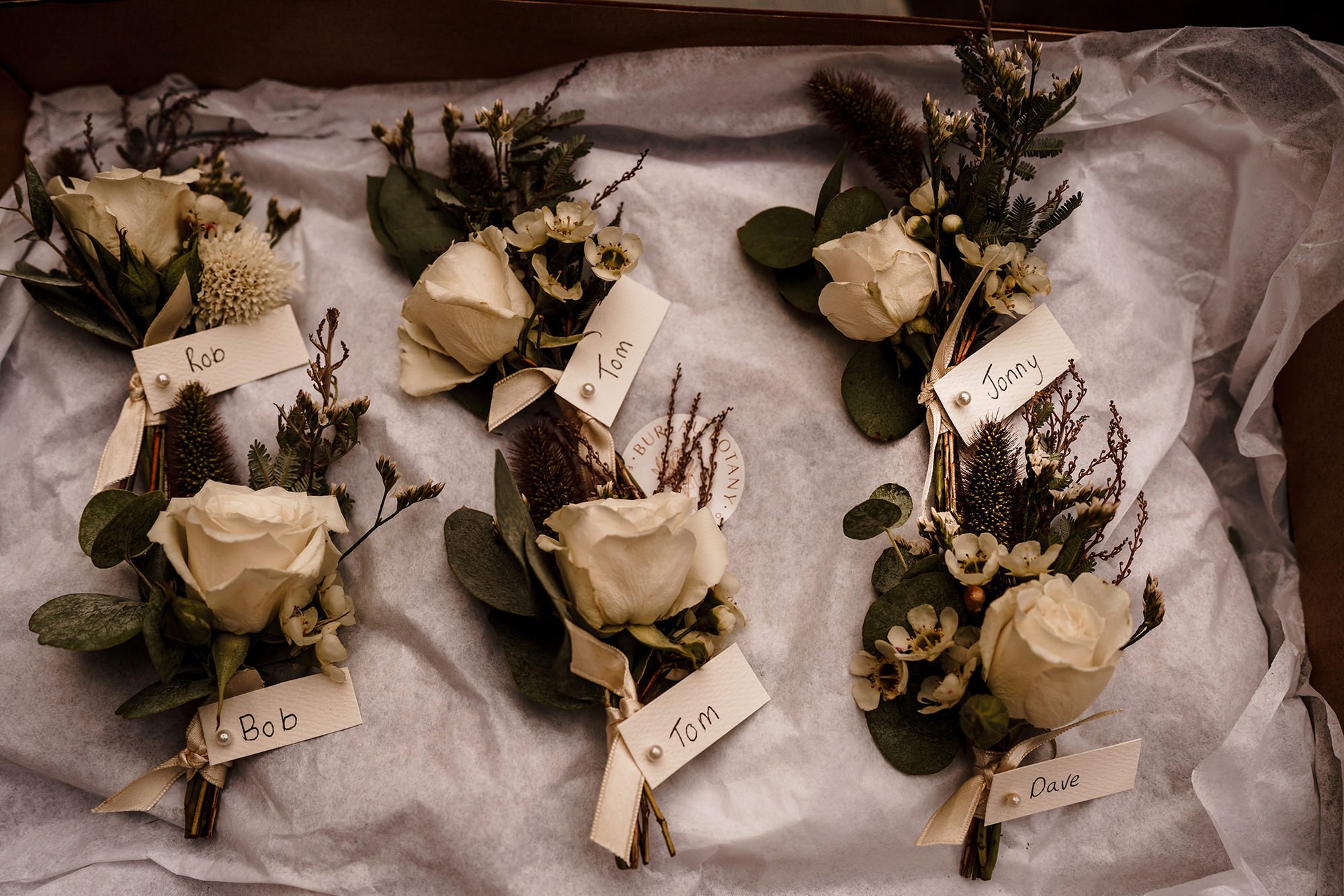groomsmen buttonholes labeled up ready