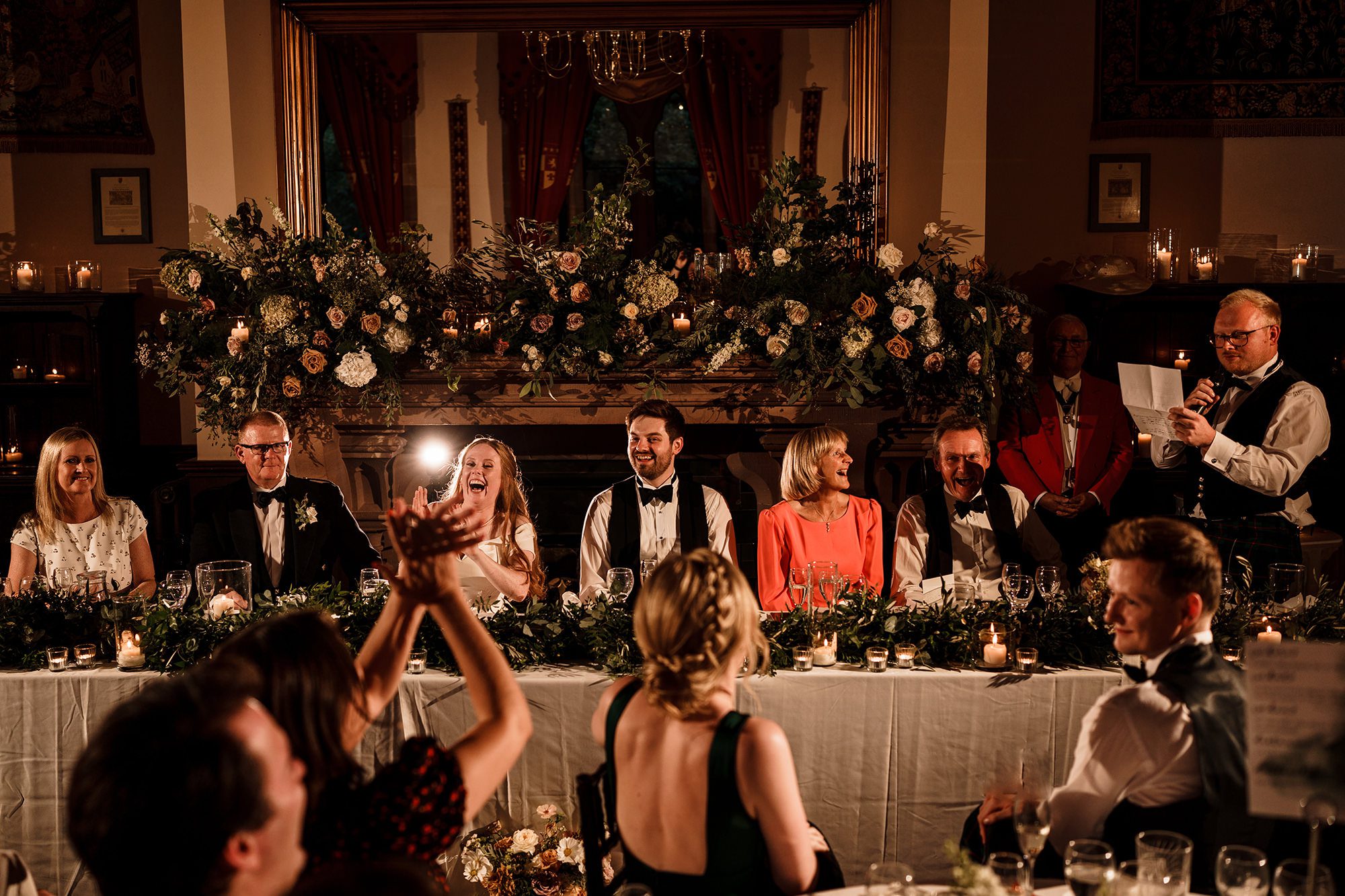 wedding party all laughing during the best mans speech