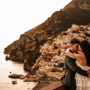 eloping couple in Italy with Positano in the background
