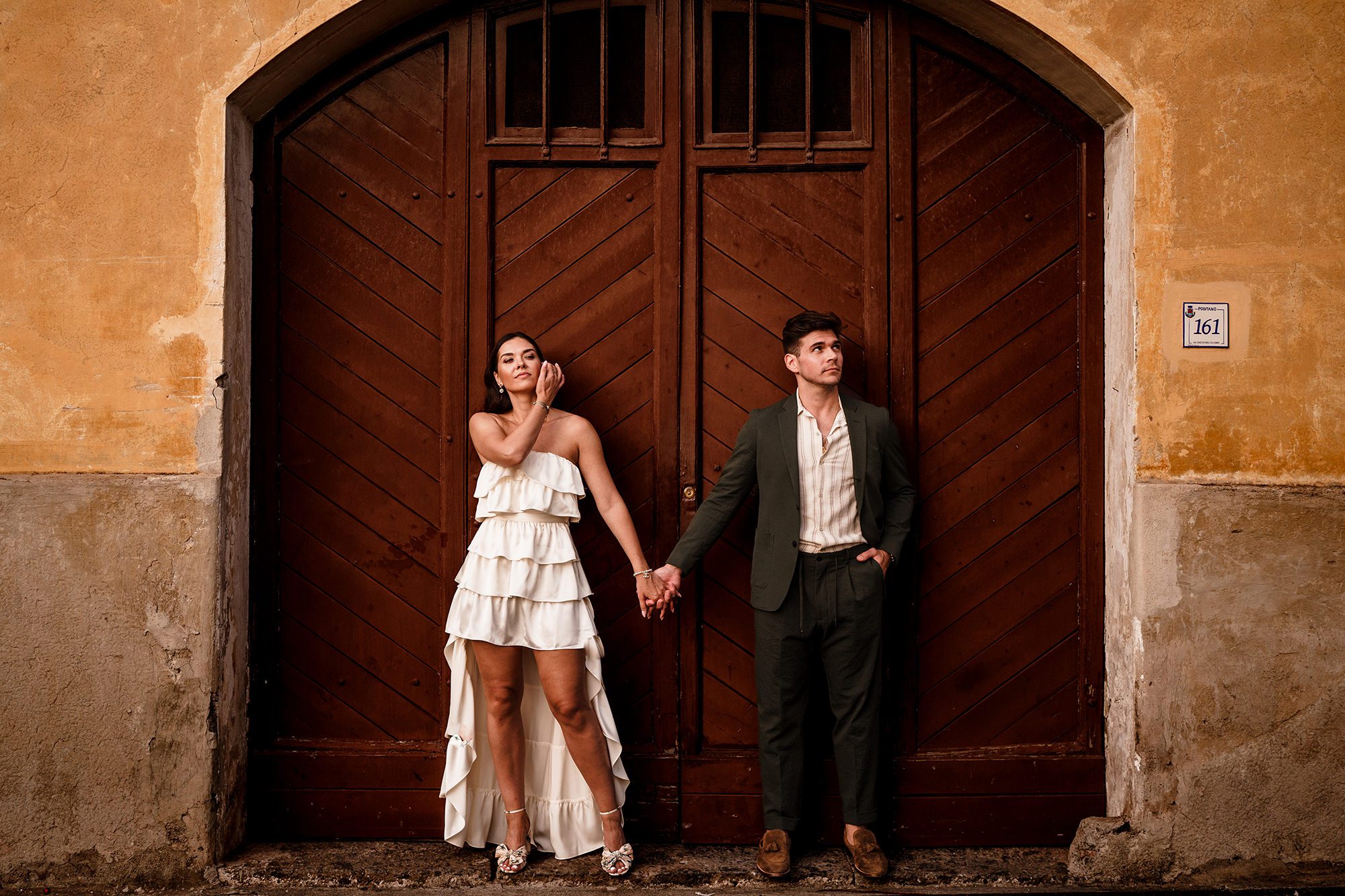 couple stand by door for elopement photograph