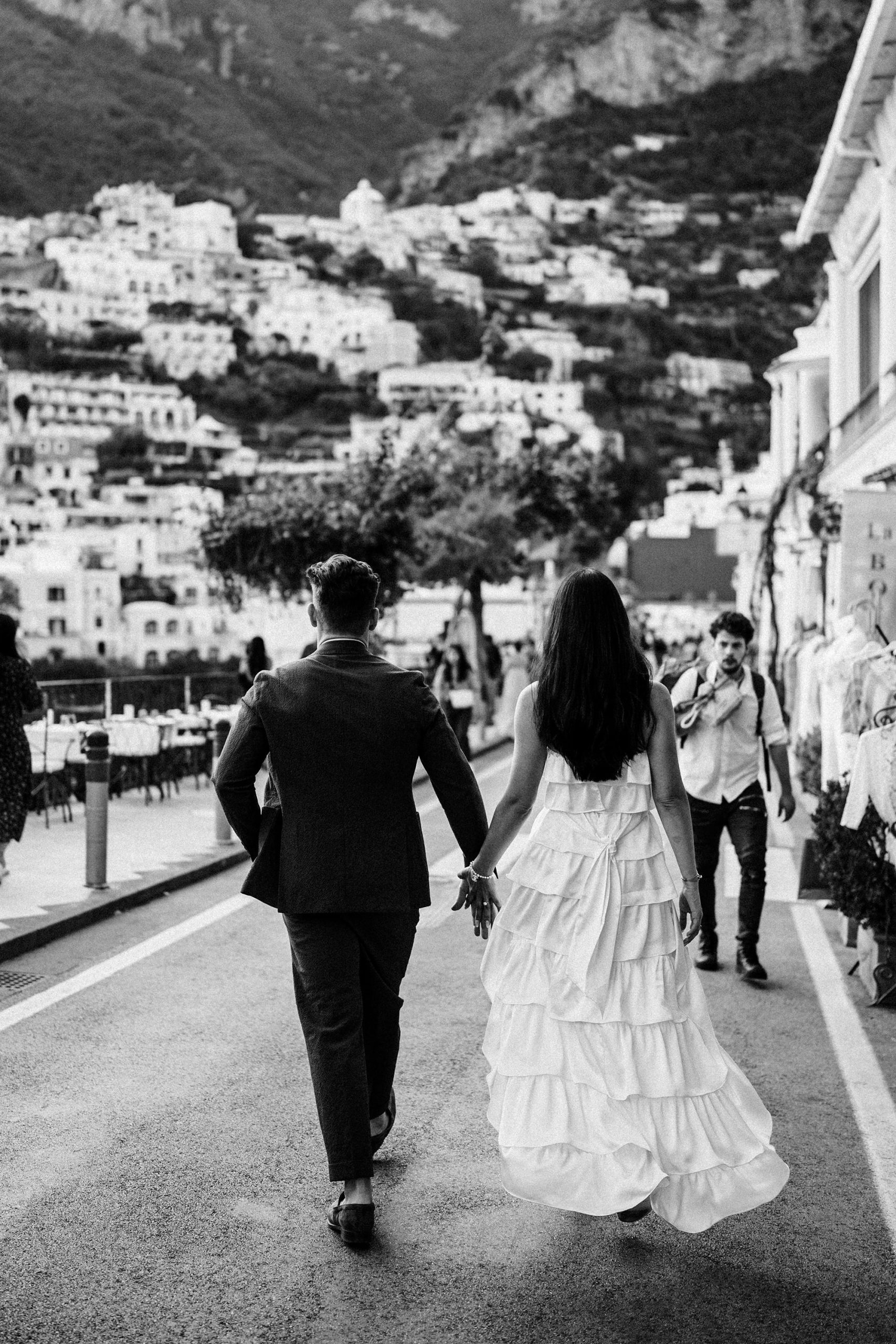 eloping couple walk through the streets on their wedding day