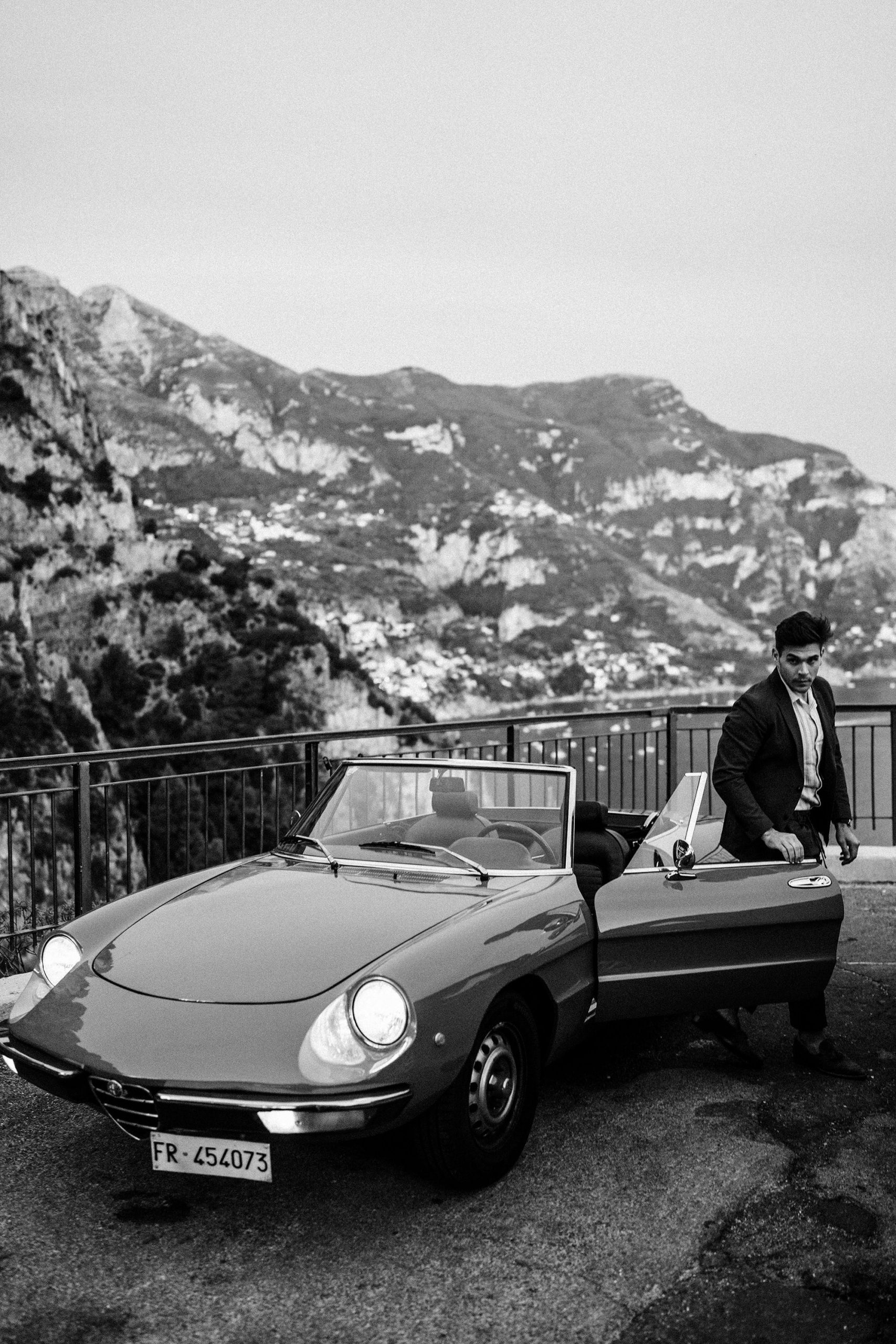groom poses for photo with his elopement photographer