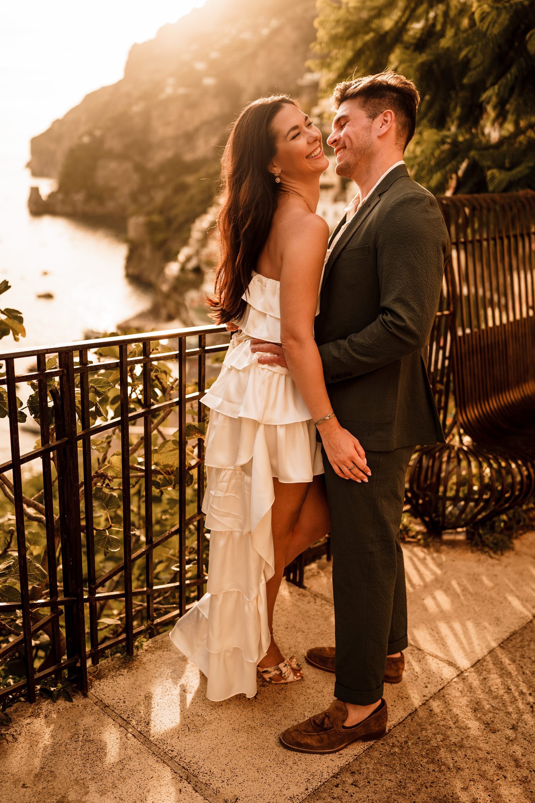 bride and groom having their elopement photographer take photos of them in Positano
