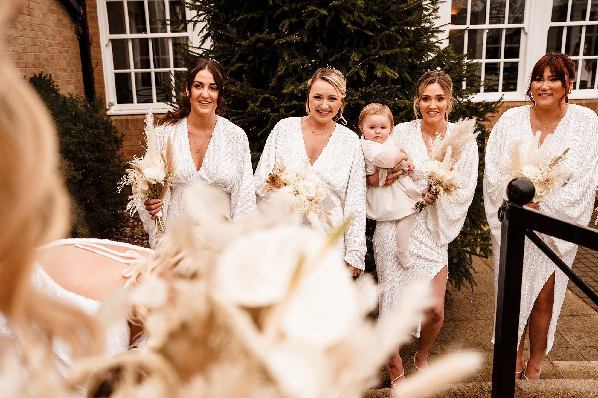 bridemaids look at bride coming out of suffolk hotel