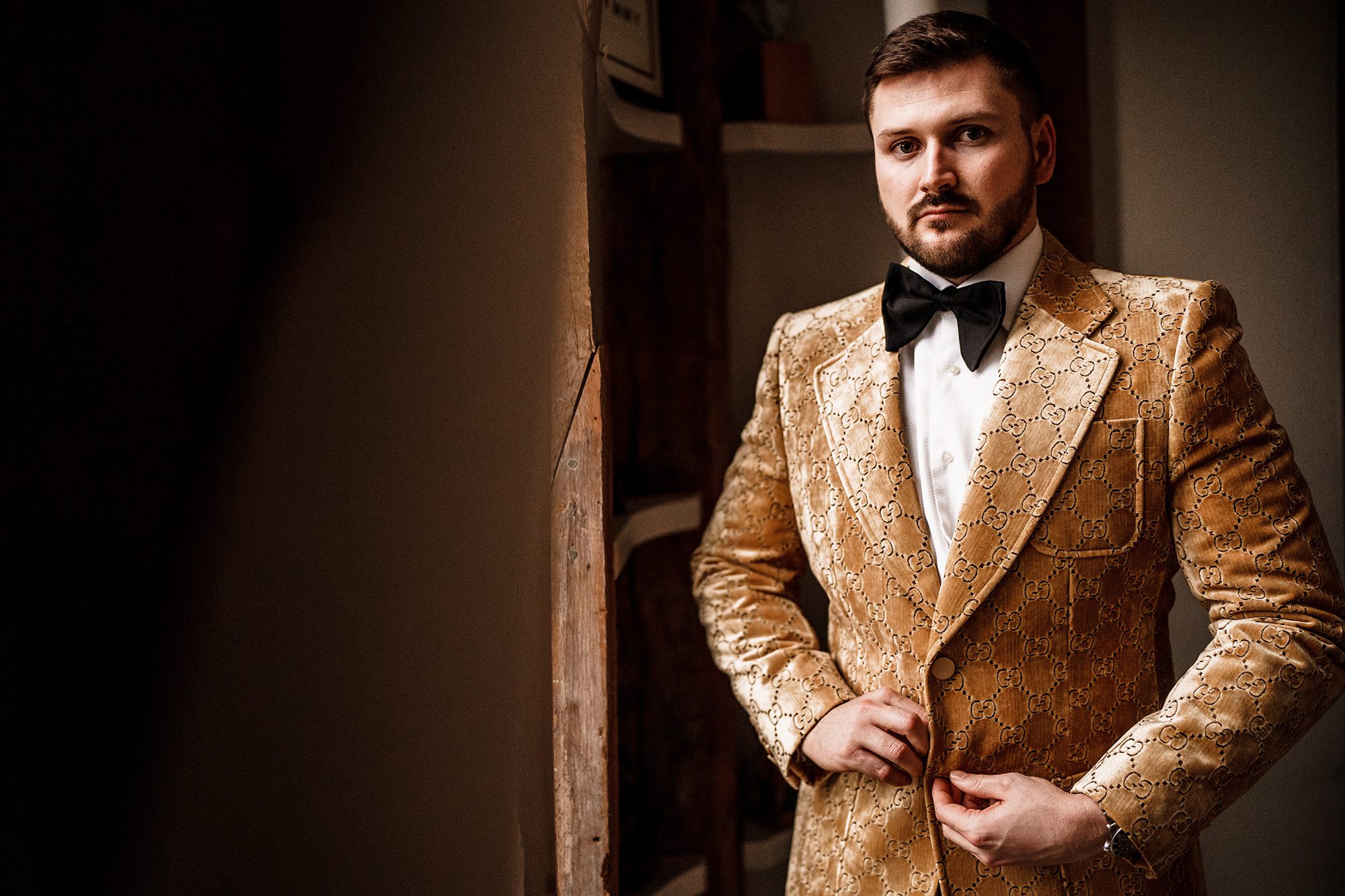groom fastens his jacket near granary estates