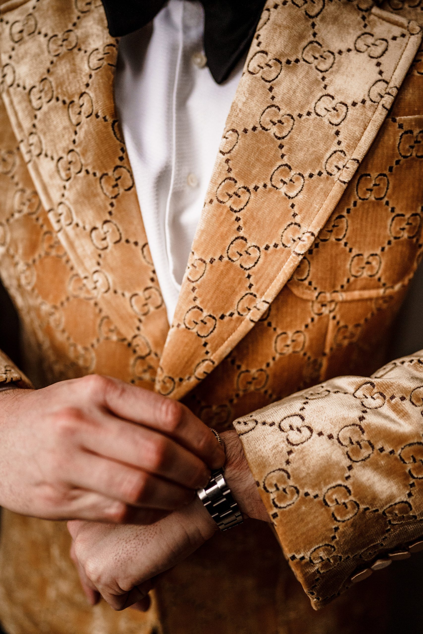 close up of groom adjusting watch for his granary estates wedding