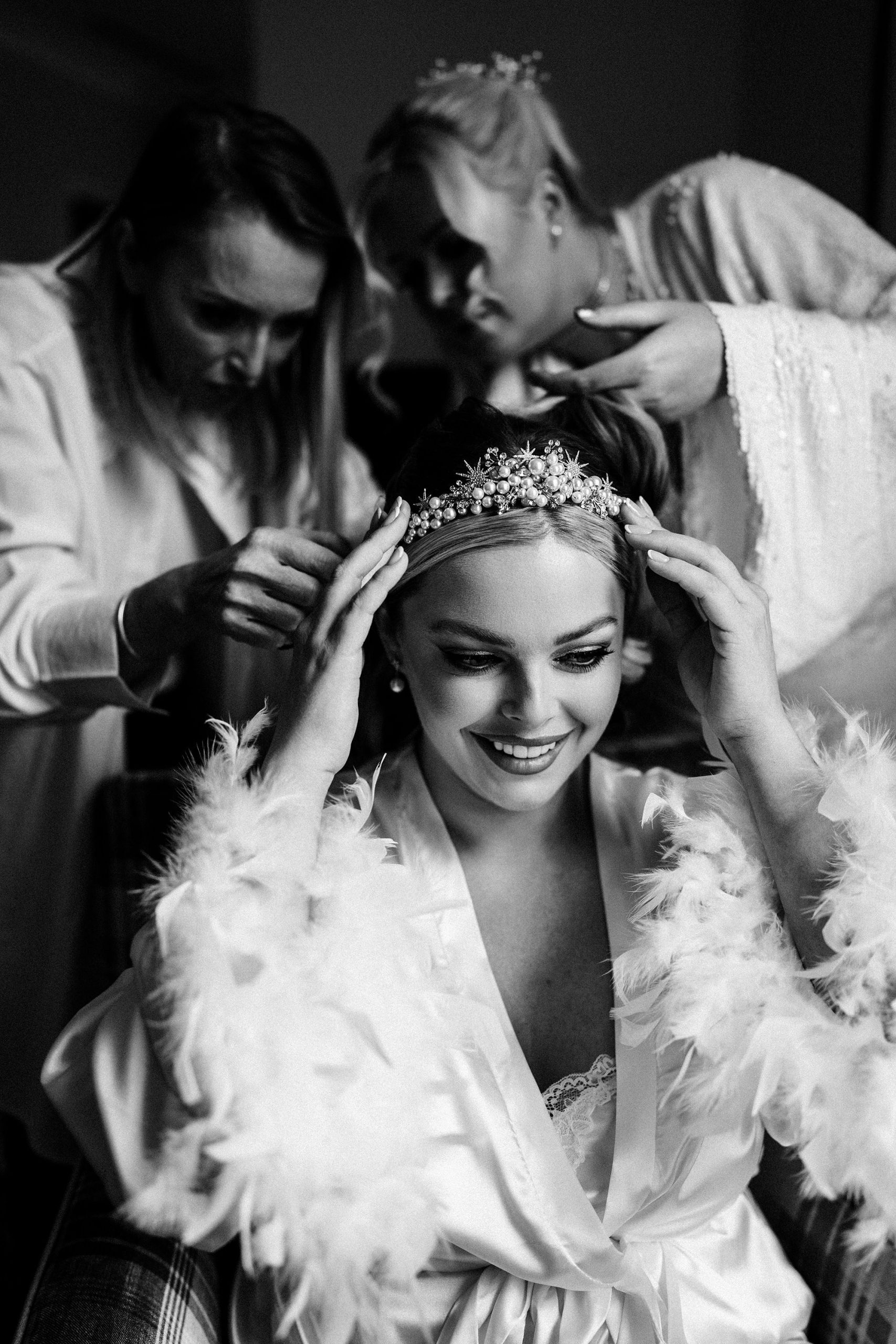 mosther and sister of bride prepping hair for wedding