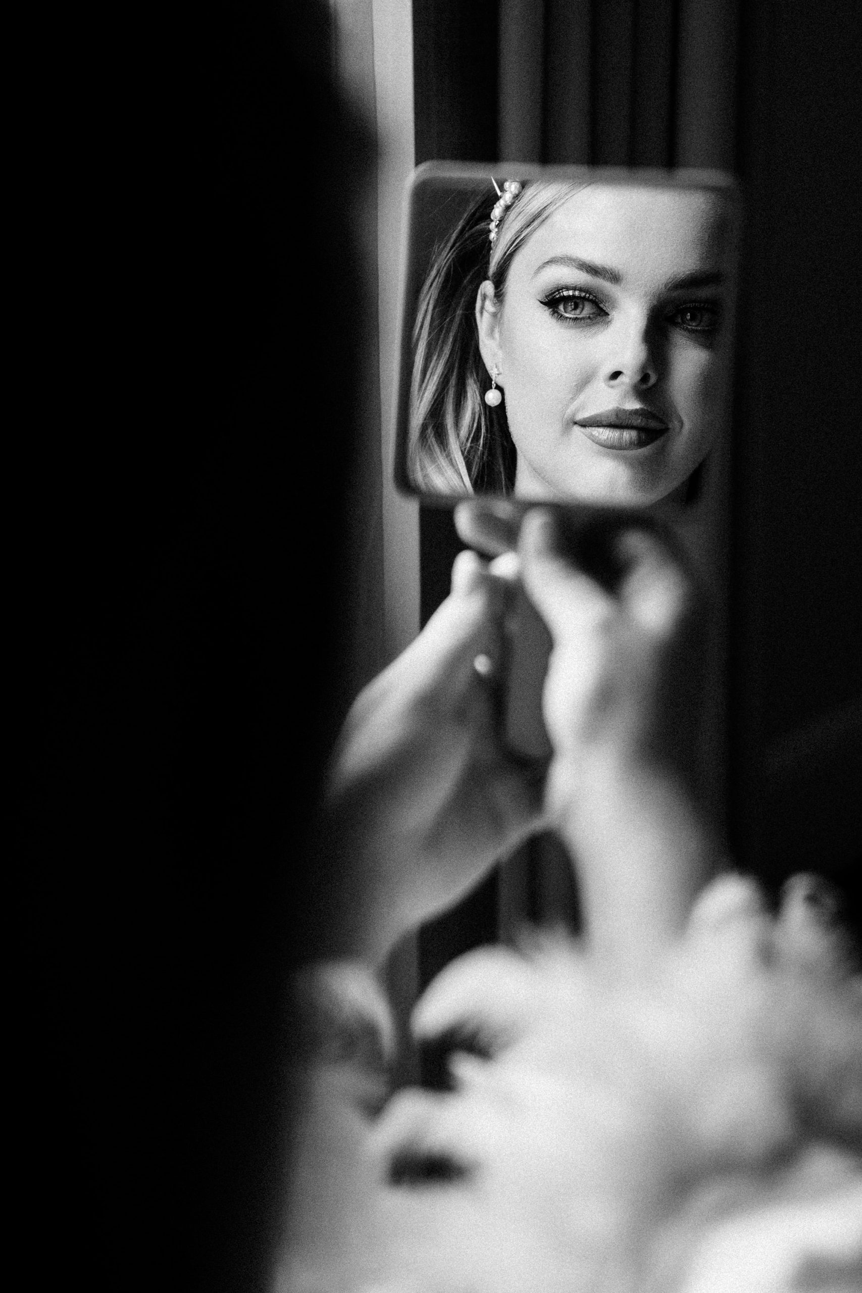 bride admiring her makeup before suffolk wedding