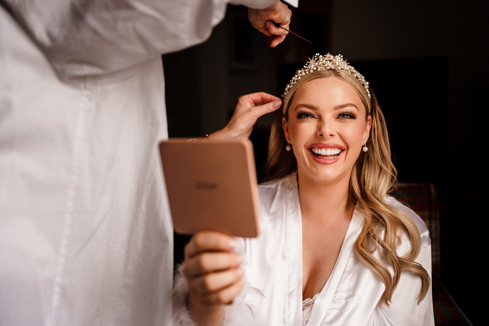 bride laughing during bridal preperations