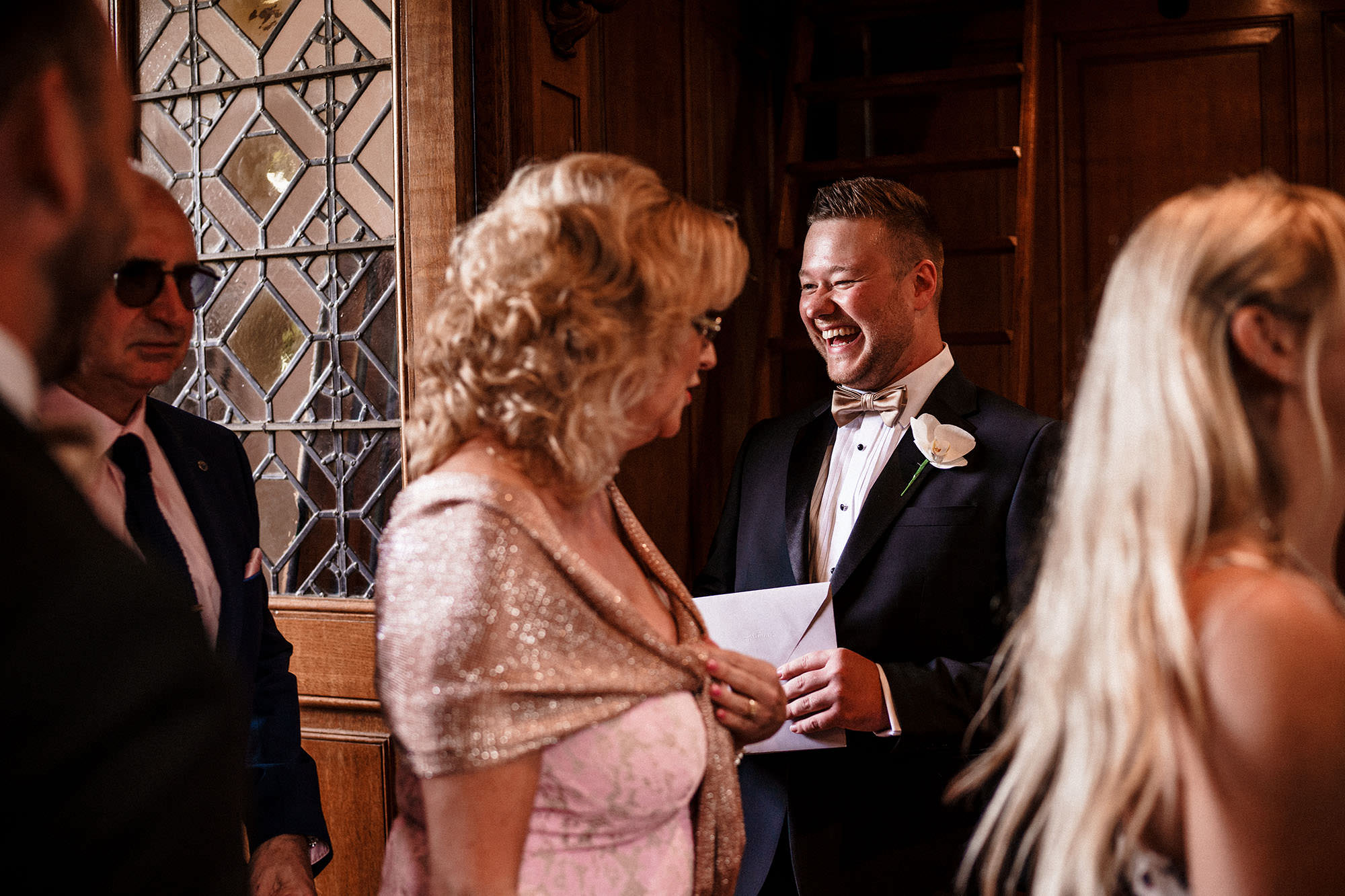 usher of the groom speaking with guests at luxury wedding at Hawkstone Hall