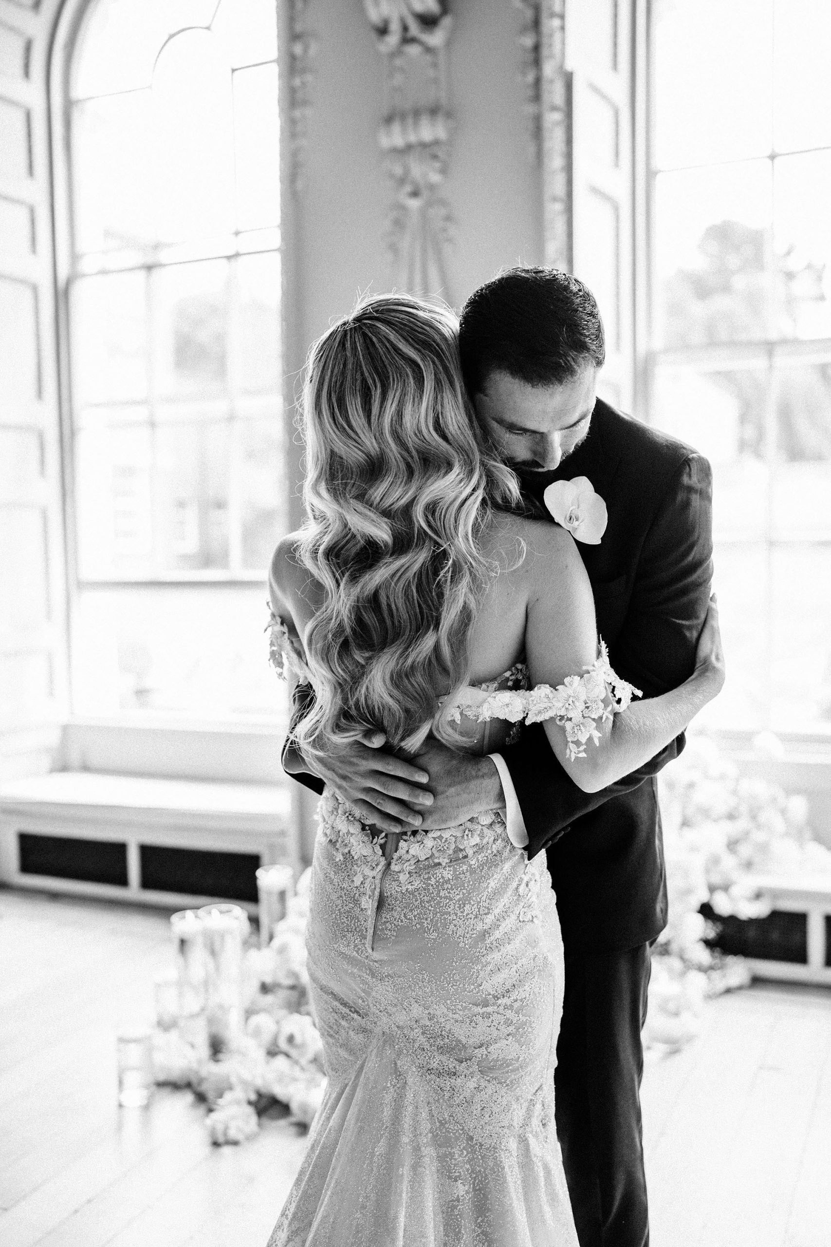 groom hugging his bride at luxury wedding at Hawkstone Hall