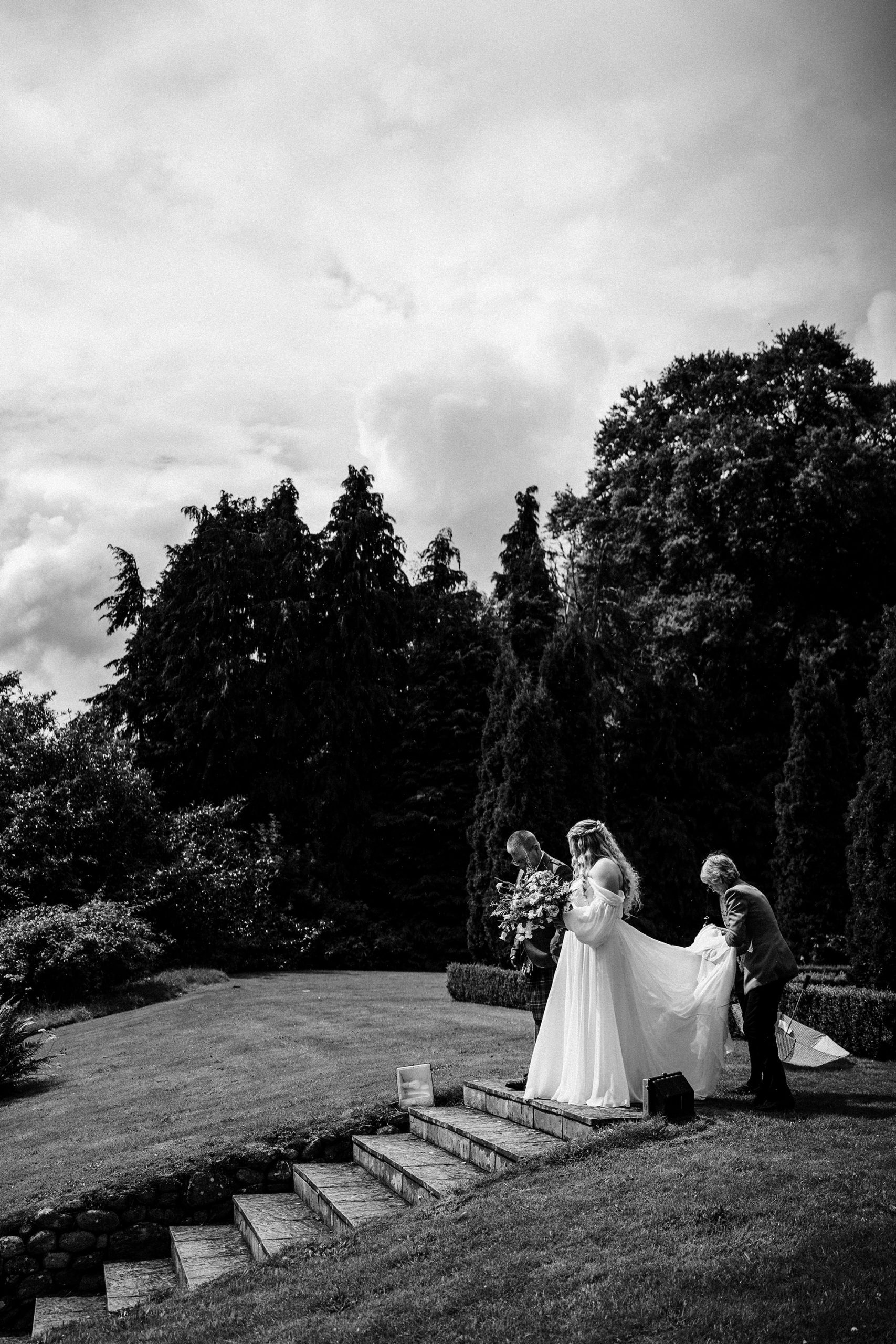 bride walking down the stairs at Achnagairn Castle wedding