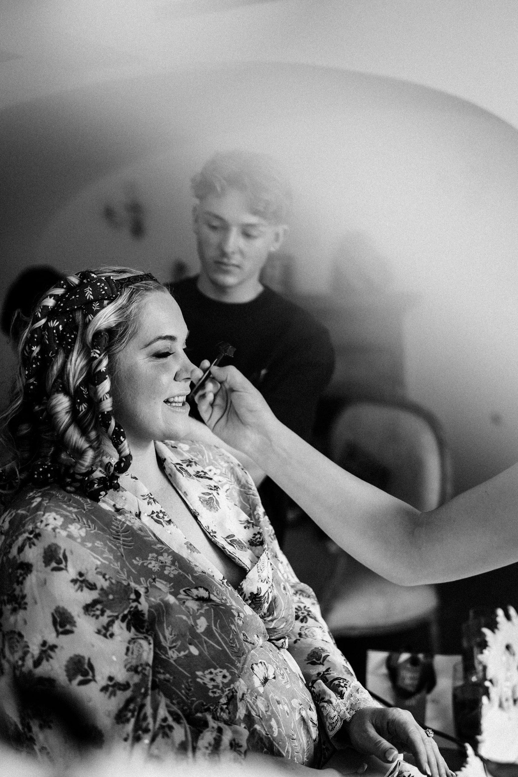 bride having makeup applied for her wedding at Achnagairn Castle