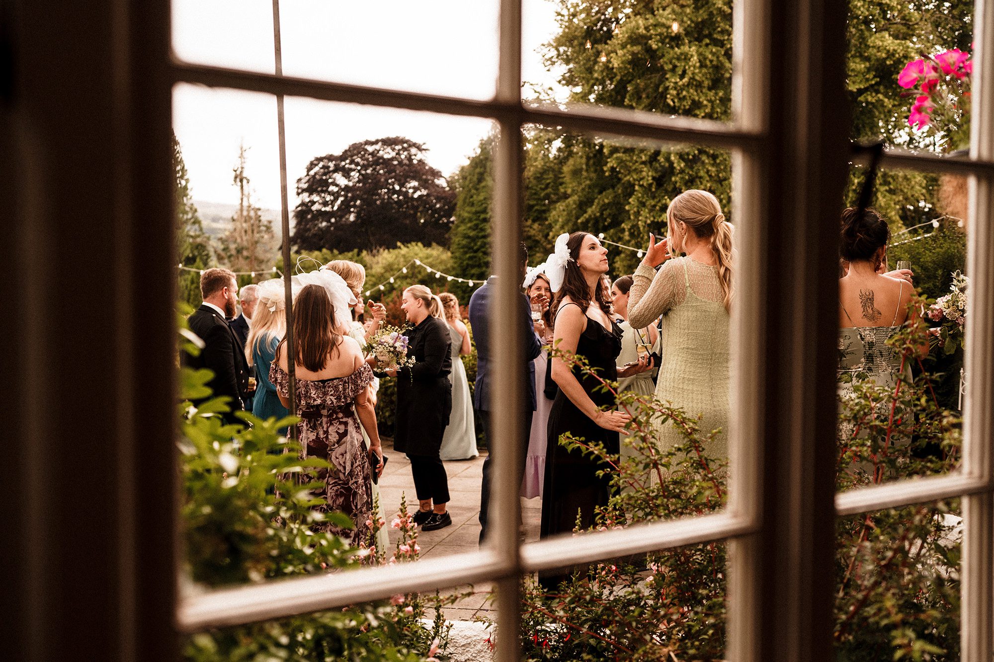 wedding guests enjoying the grounds of Achnagairn Castle in scotland