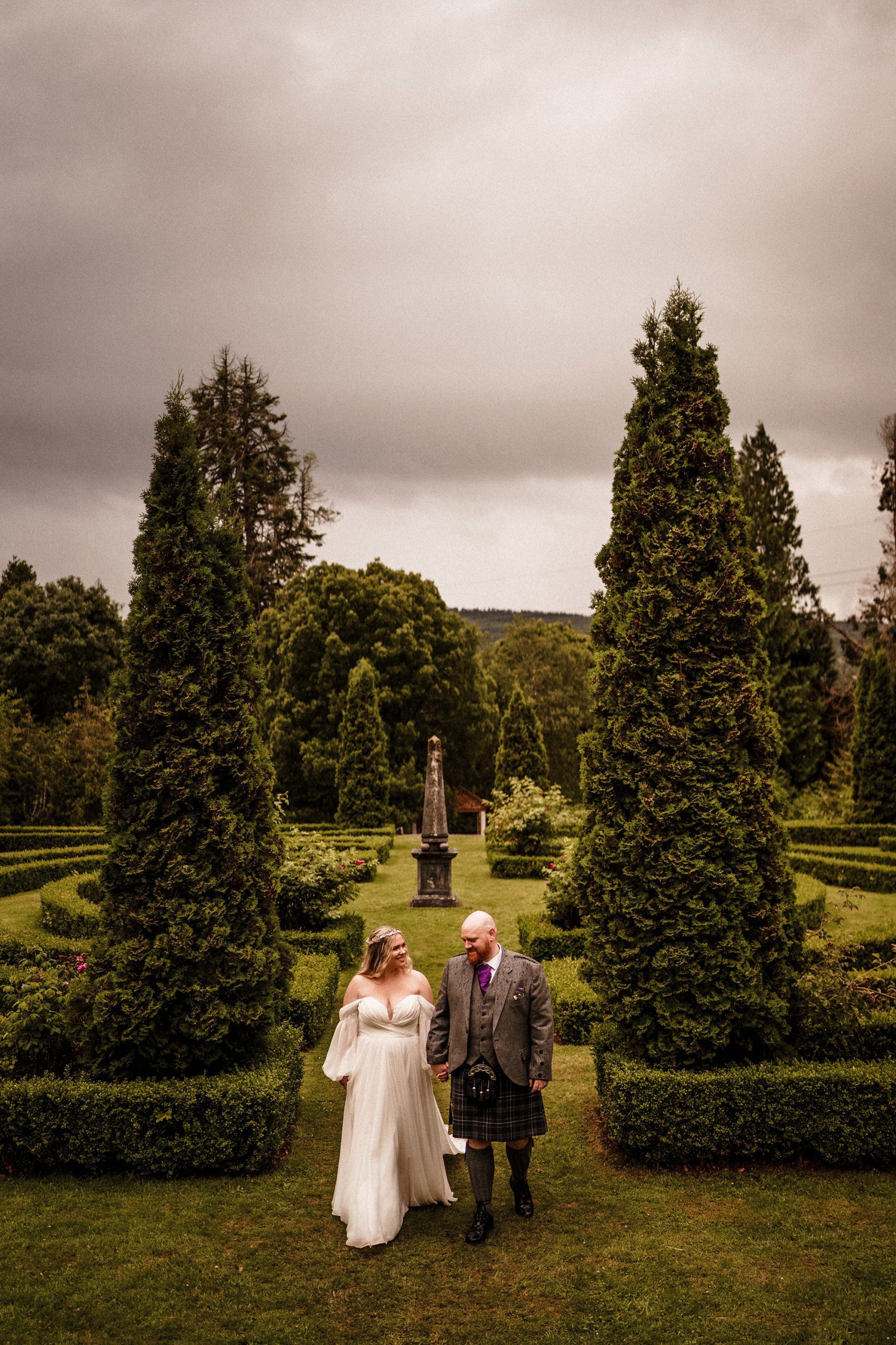 couple walking on the grounds of Achnagairn Castle