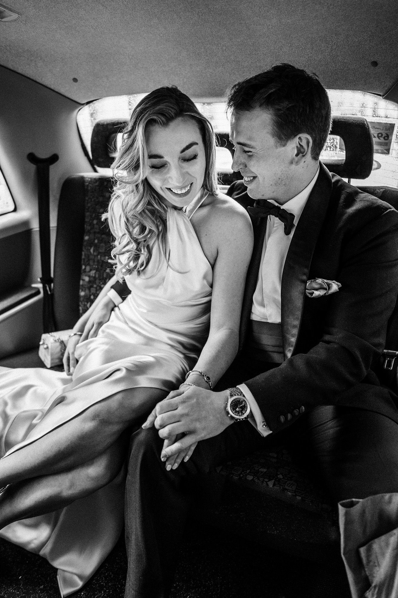 bride and groom in taxi during their london wedding