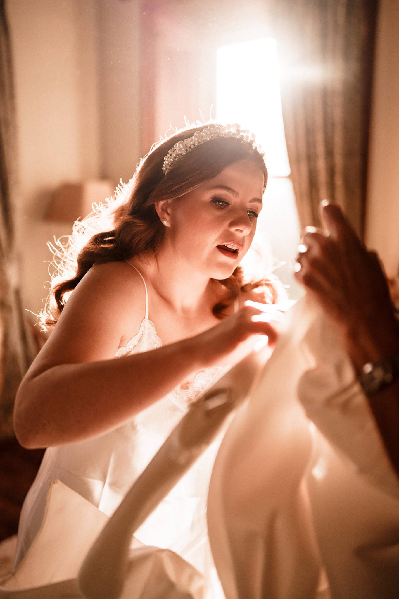 bride attending to her wedding dress